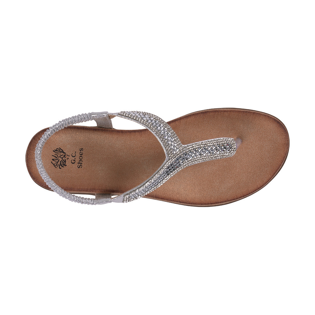 Brown sandal with silver embellishments on a white background
