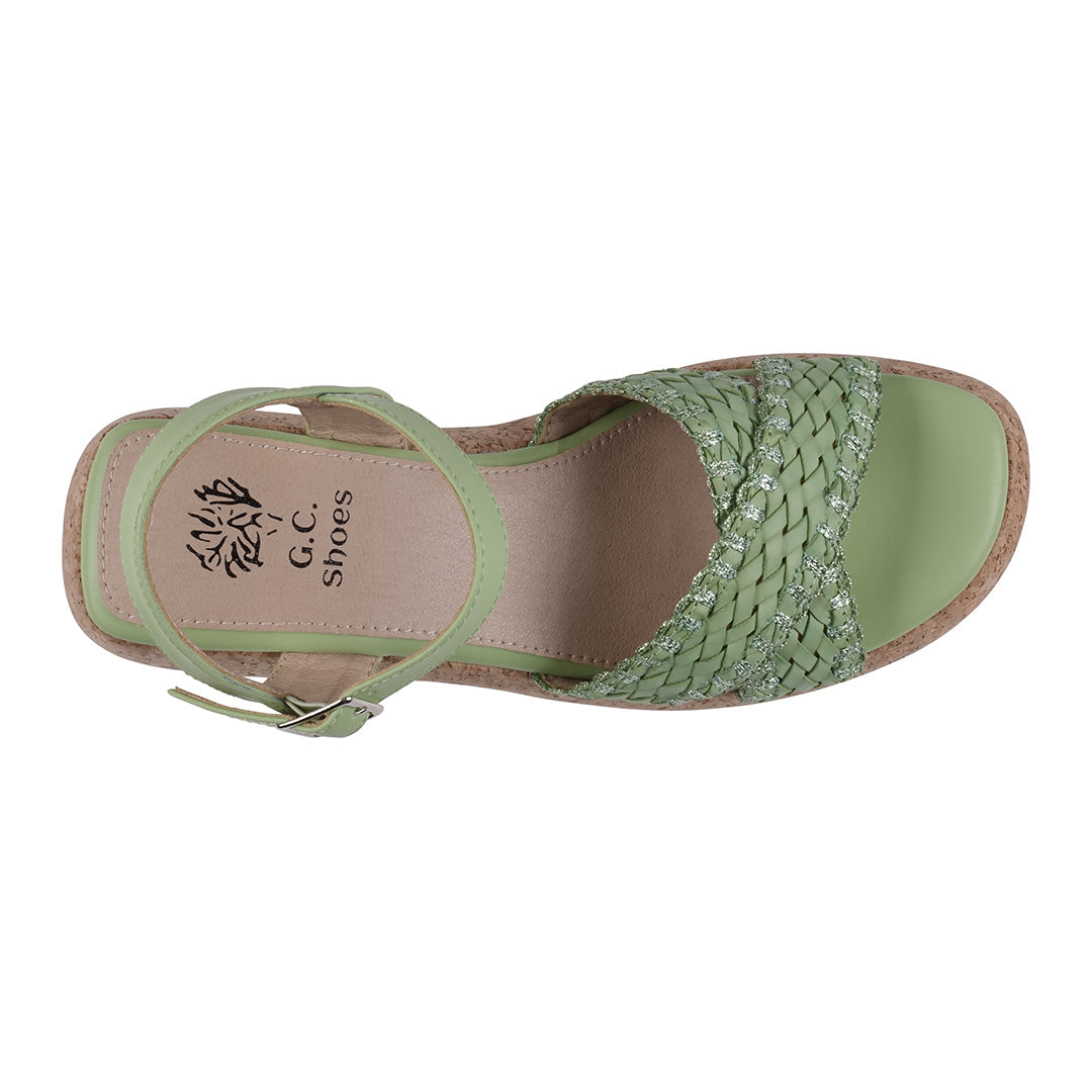 Green sandal with woven design on a white background