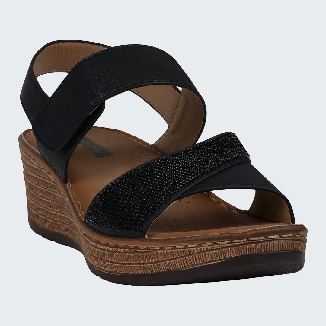 Black wedge sandal with brown sole on a white background