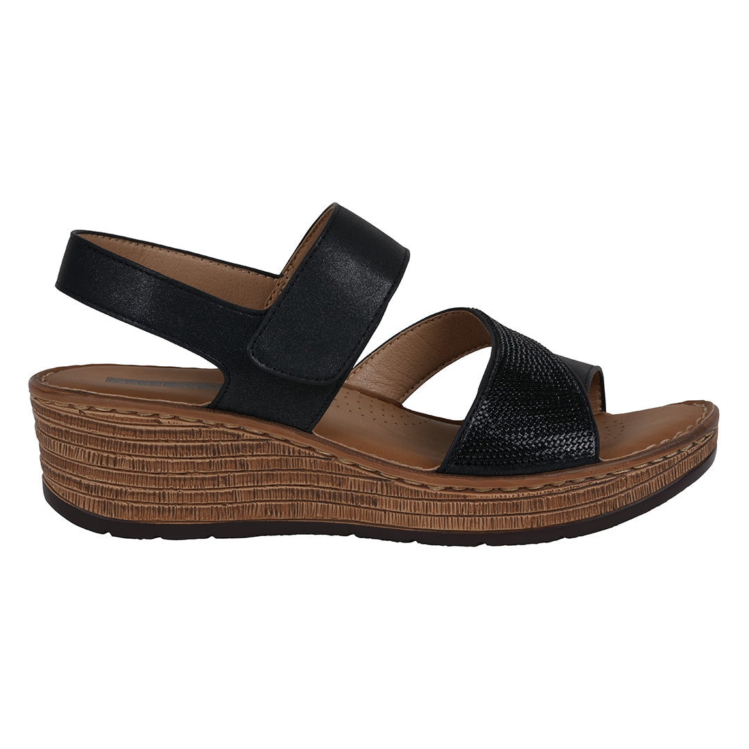 Black wedge sandal with brown sole on a white background
