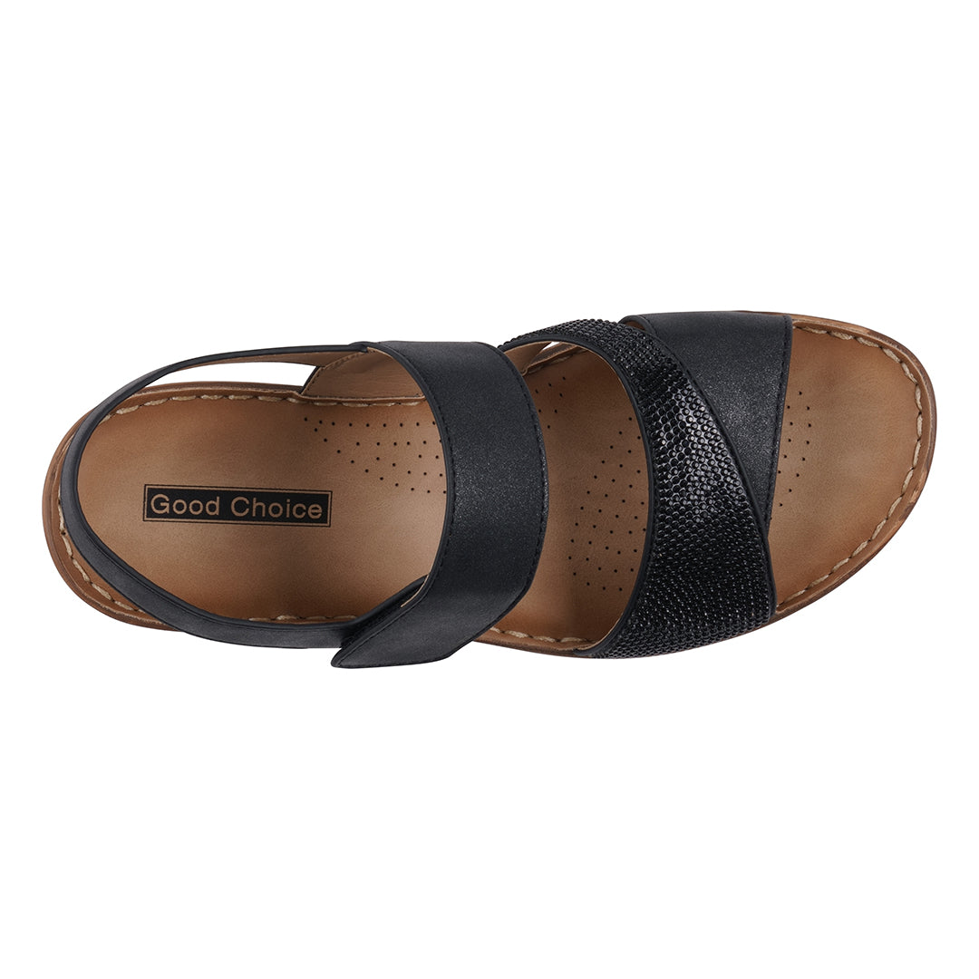 Black sandal with brown sole on a white background