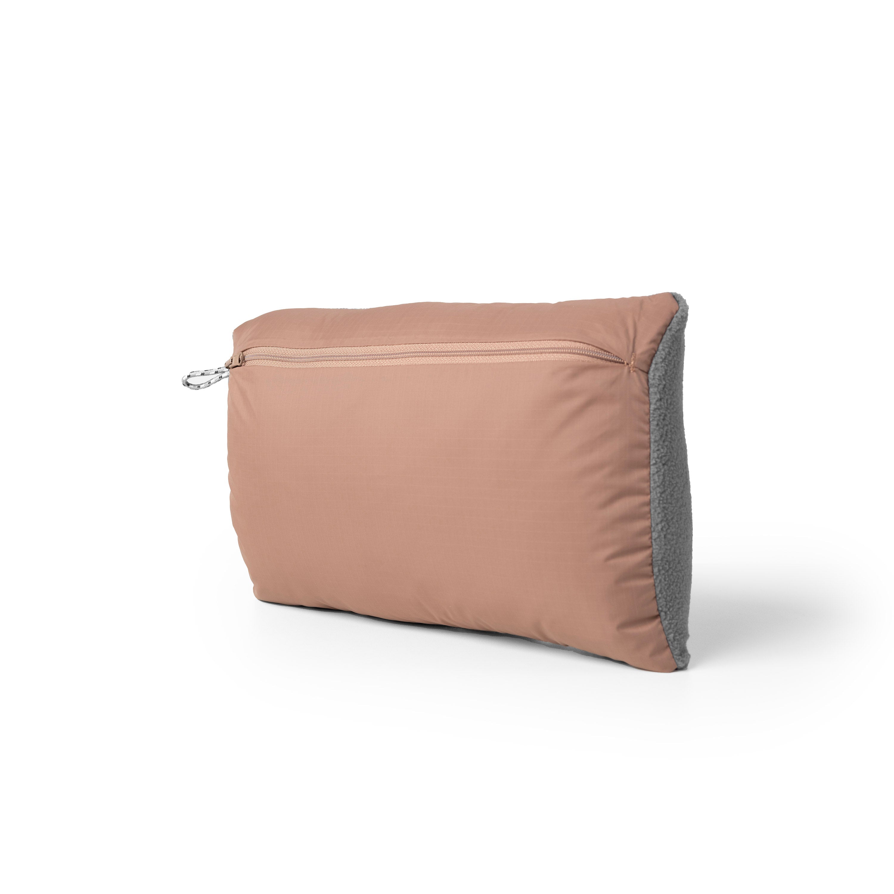 Brown travel pillow with gray zipper on a white background