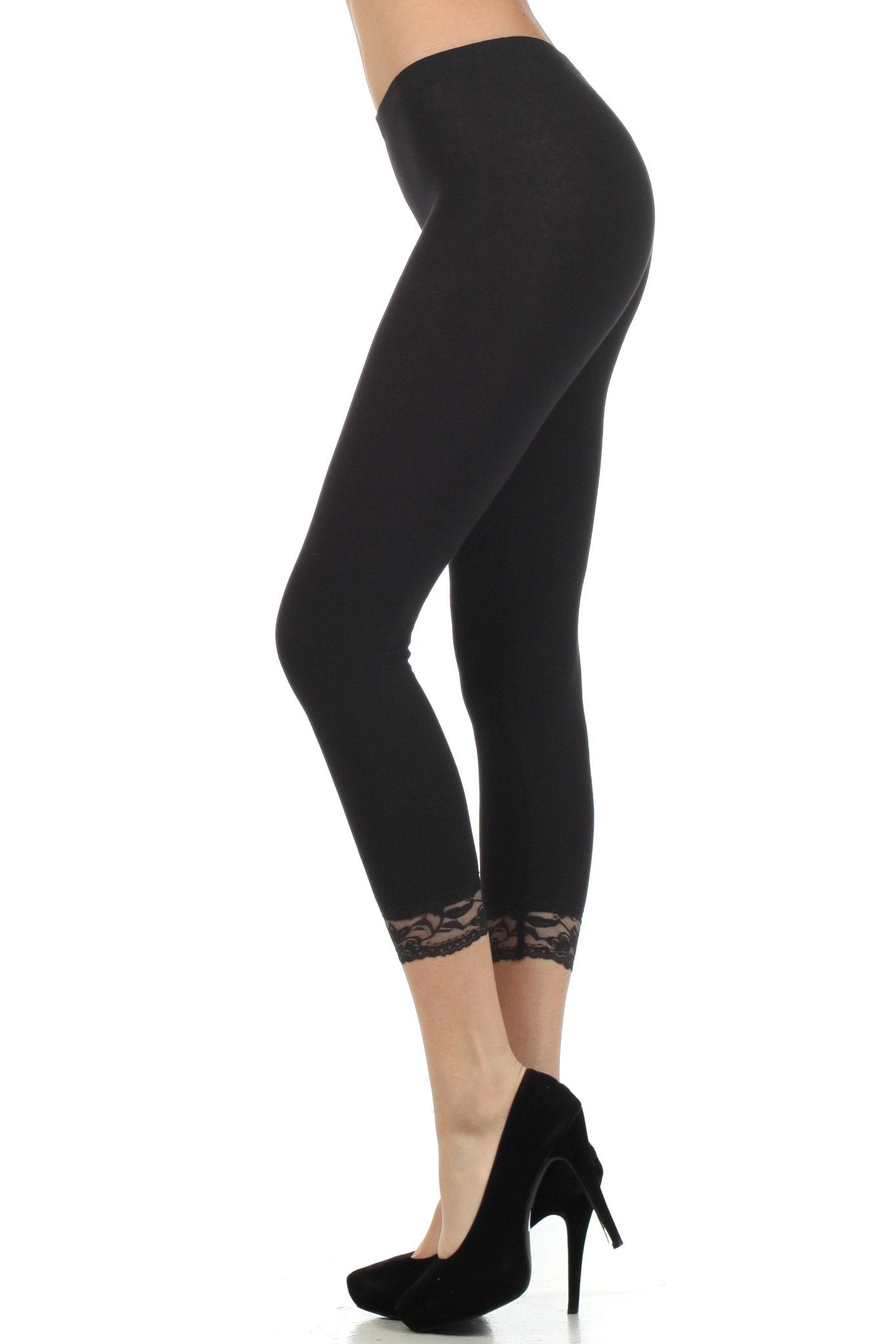Black leggings with lace trim worn by a person on a white background