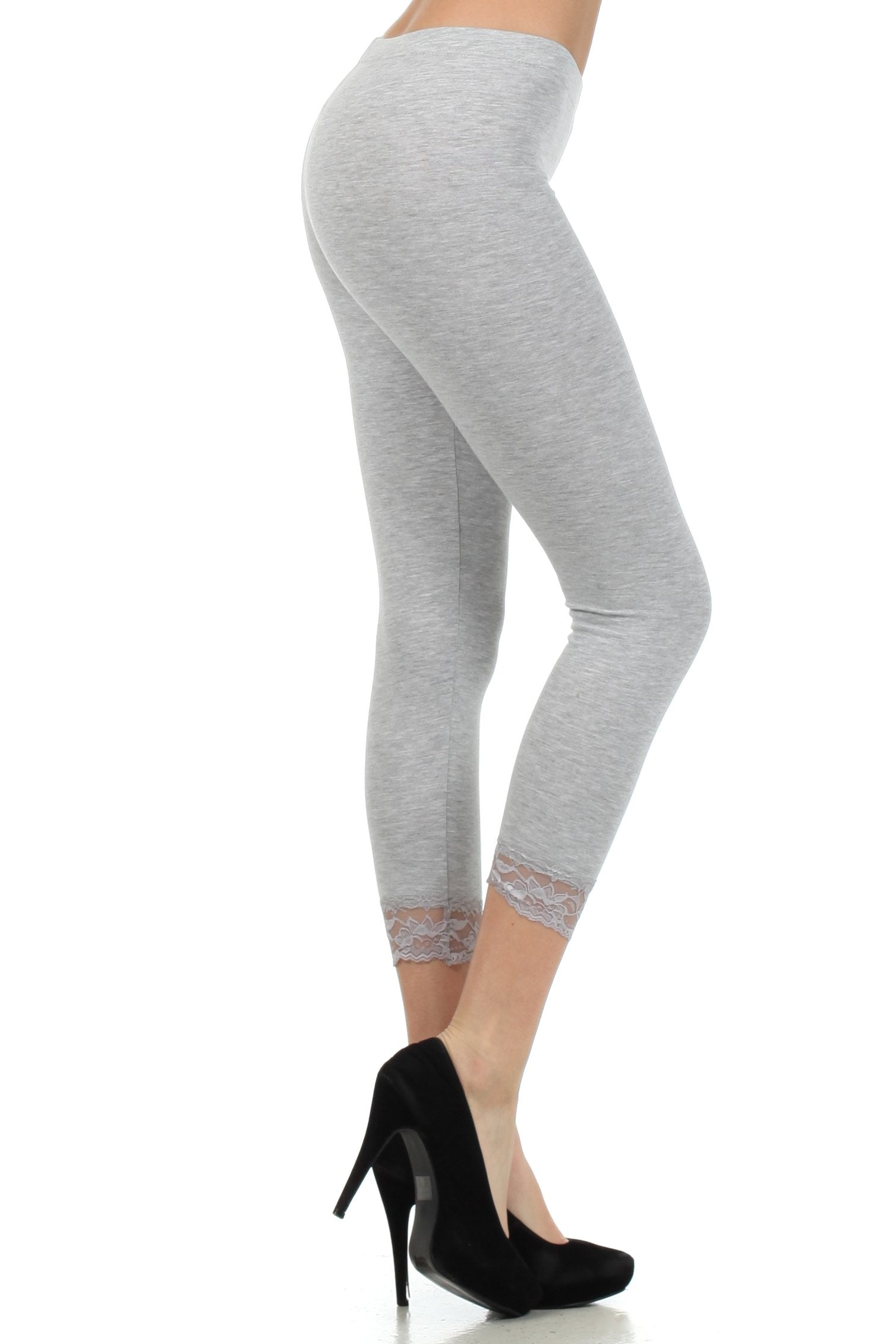 Gray leggings with lace trim worn by a person on a white background