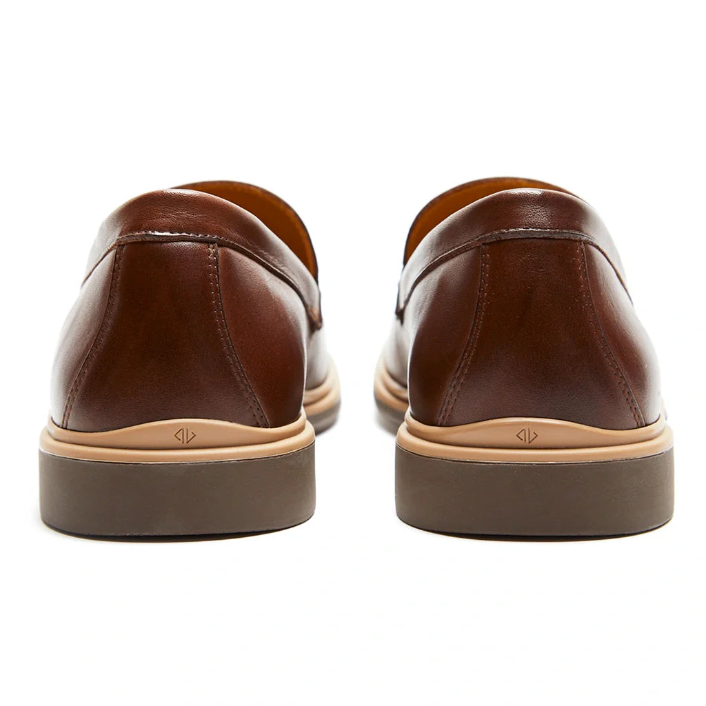 Brown leather shoes with tan soles on a white background