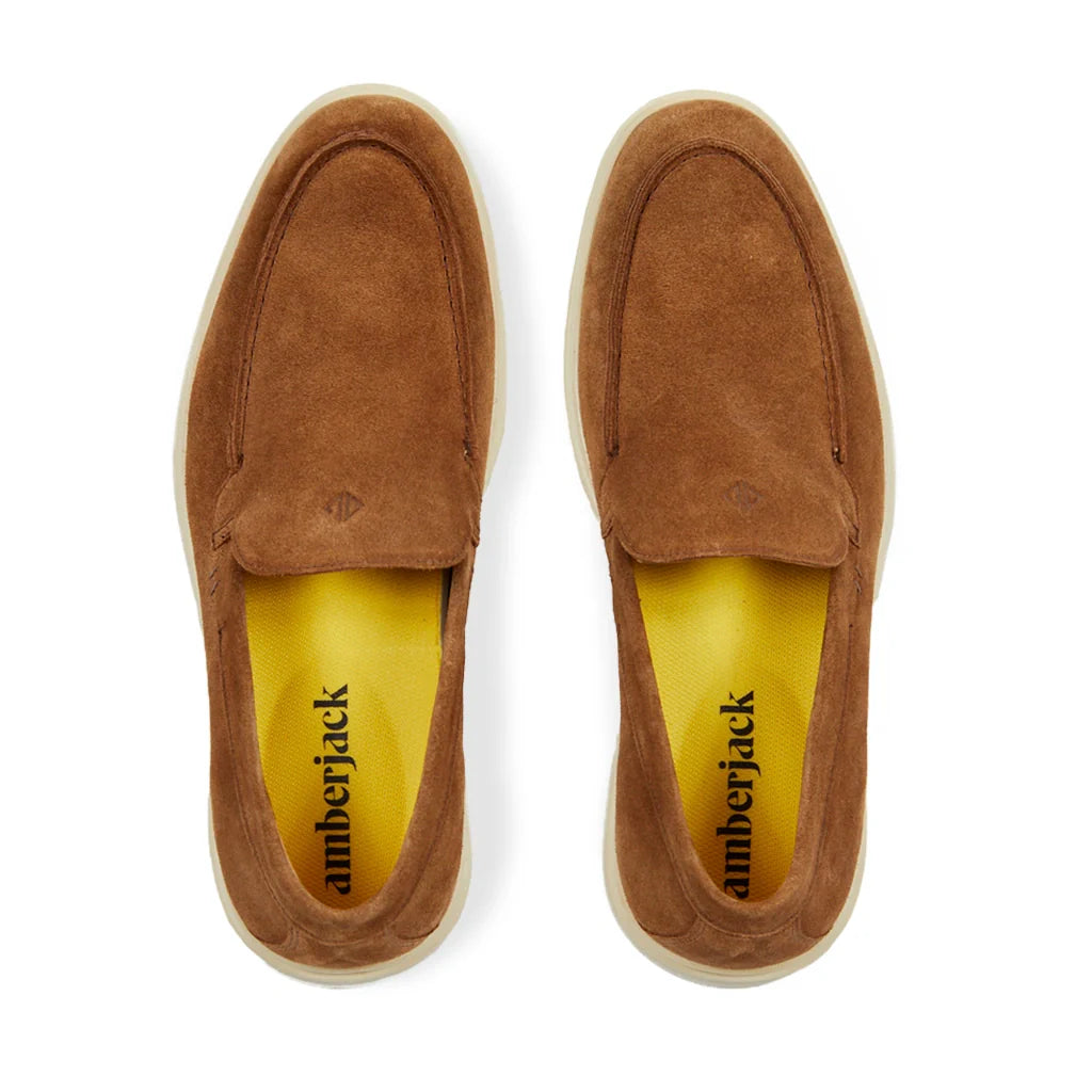 Pair of brown suede shoes with 'amberjack' branding on a white background