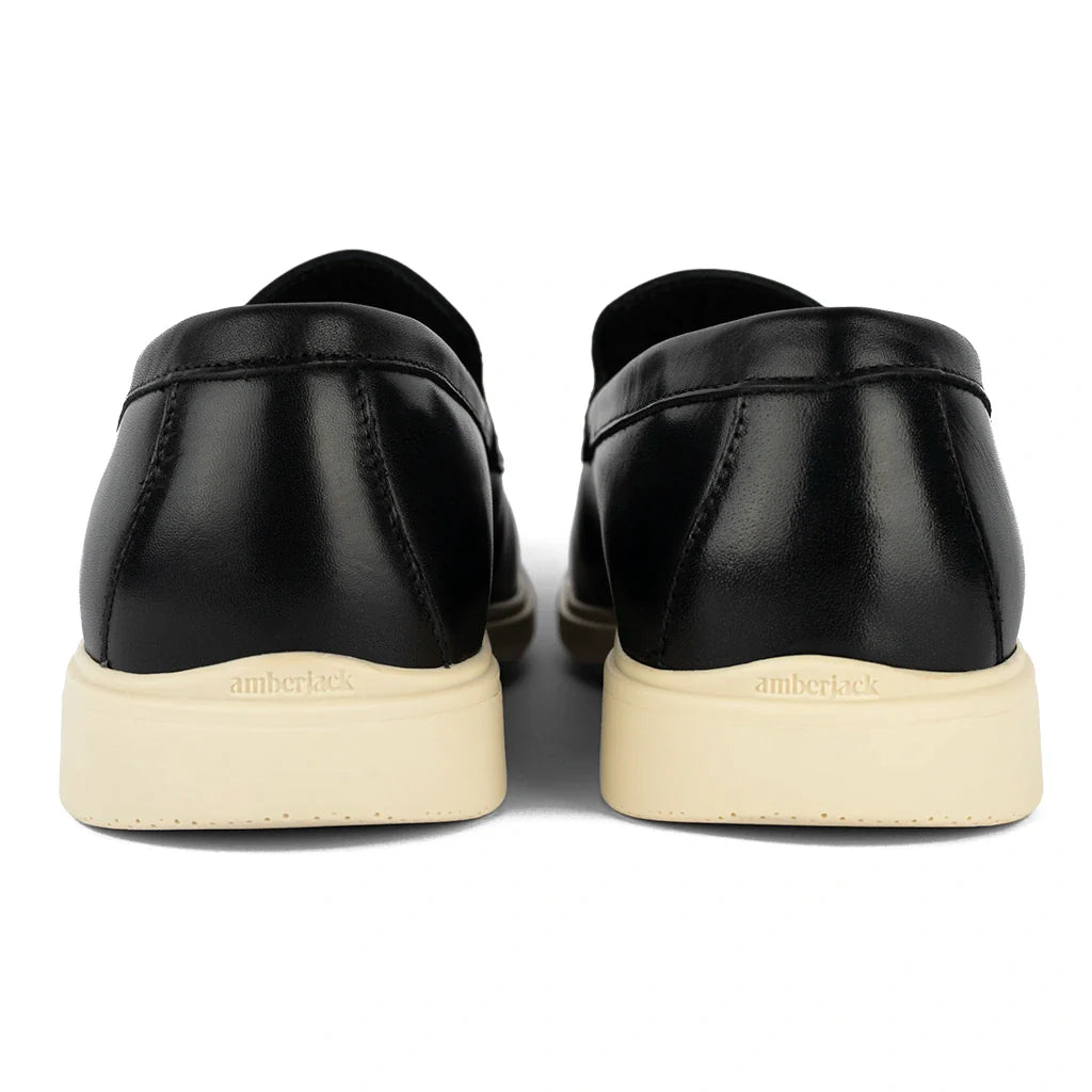 Black leather shoes with white soles on a white background