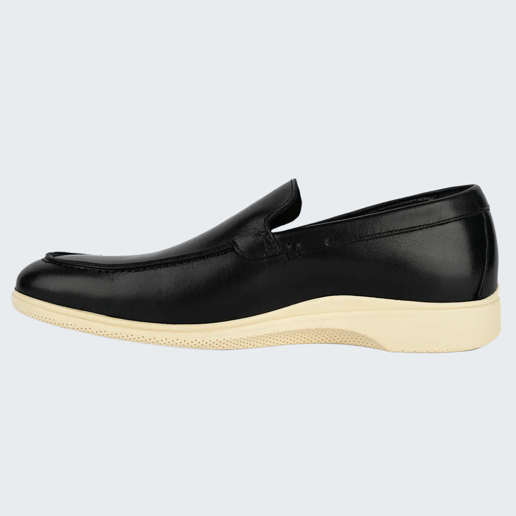 Black loafer shoe with a white sole on a white background