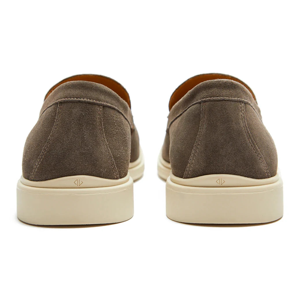 Pair of brown slip-on shoes with white soles on a white background