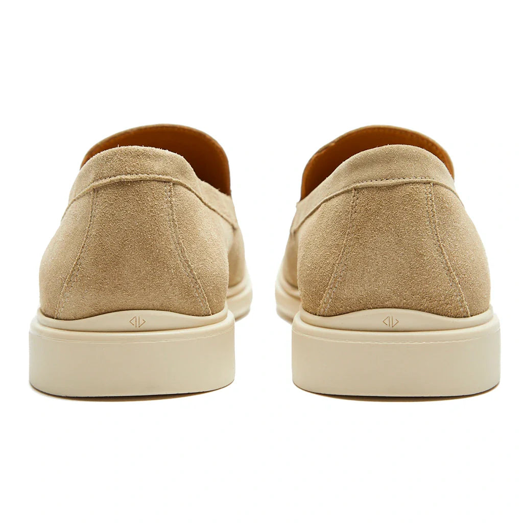 Beige slip-on shoes with white soles on a white background