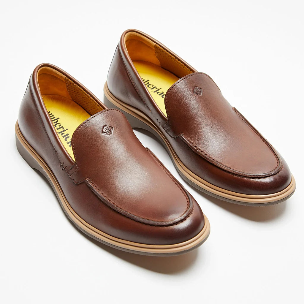 Pair of brown leather loafers on a white background