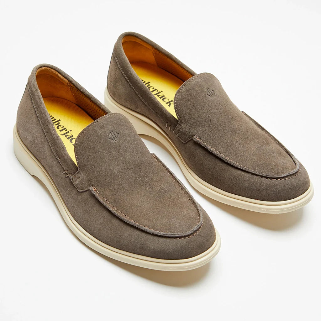 Pair of brown suede loafers on a white background