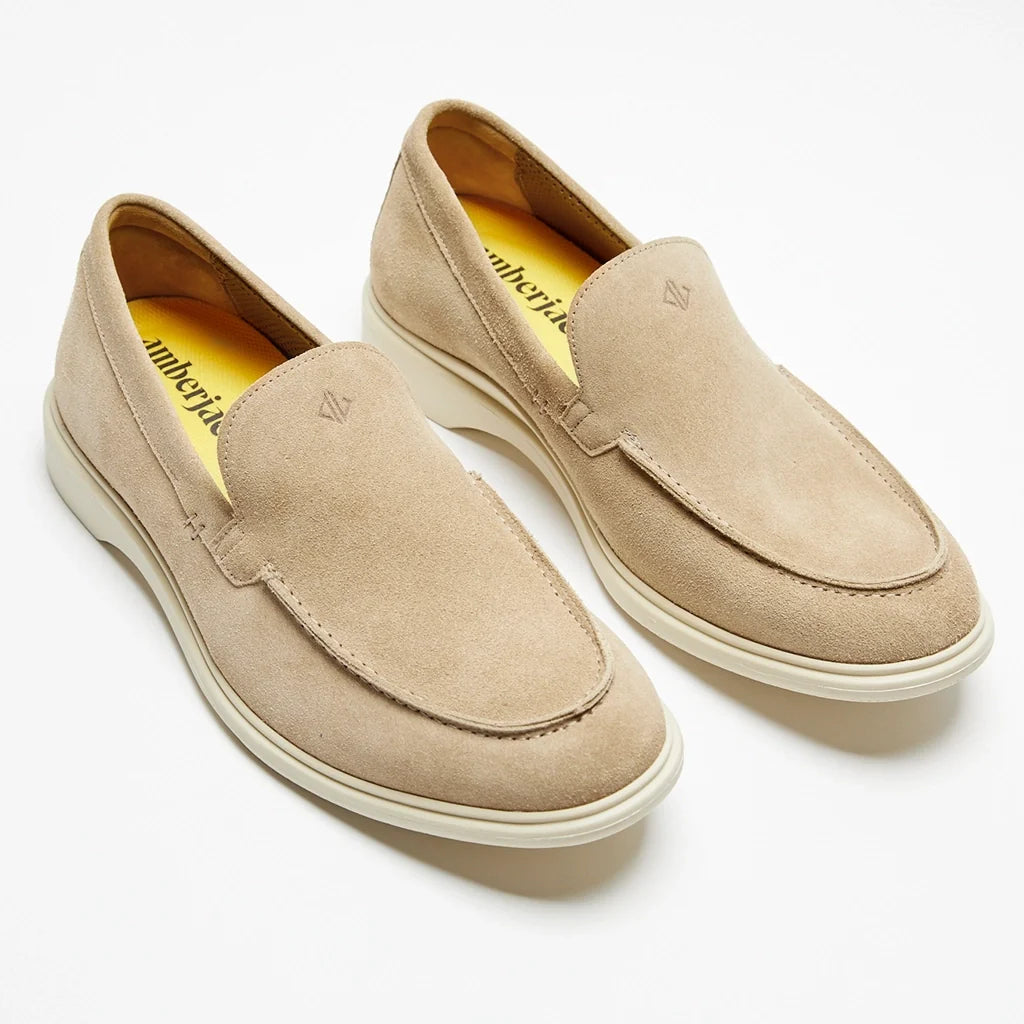Pair of beige loafers on a white background