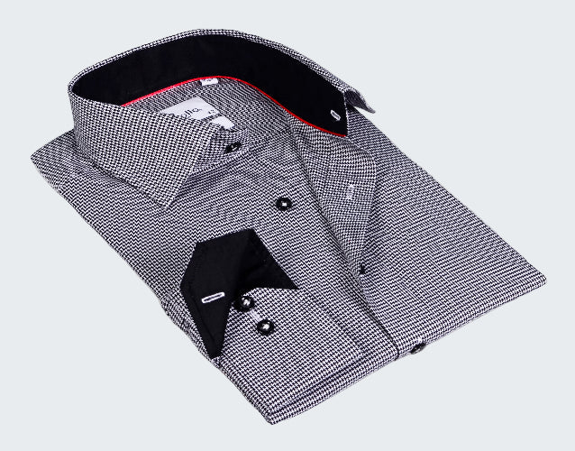 Folded black and white checkered dress shirt with a red interior on a white background