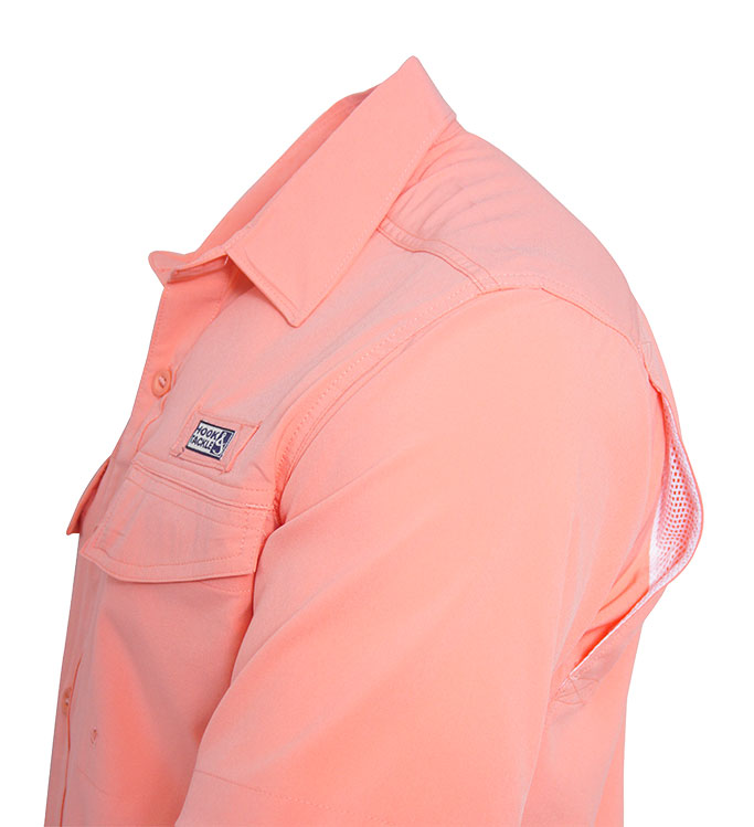 Close-up of a peach-colored shirt with a brand logo on a white background