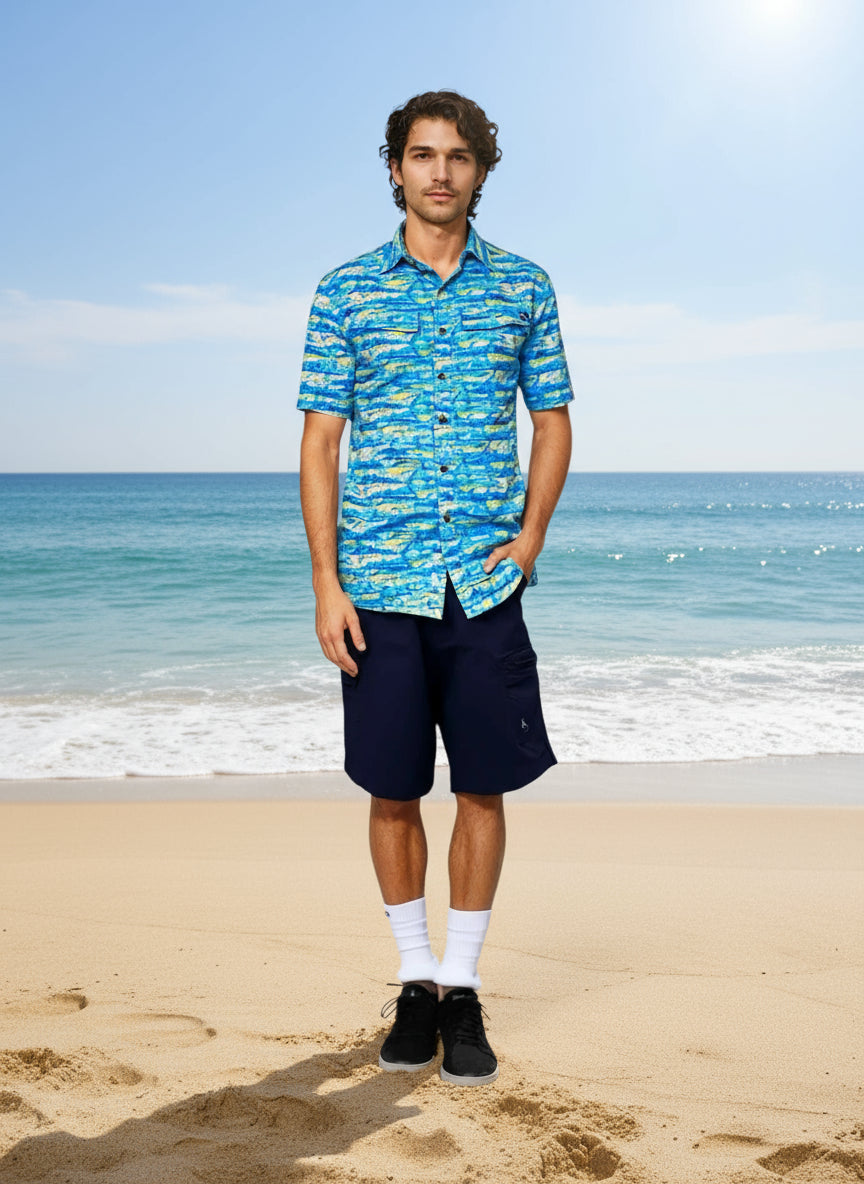 Man wearing a blue patterned shirt and navy shorts on a white background