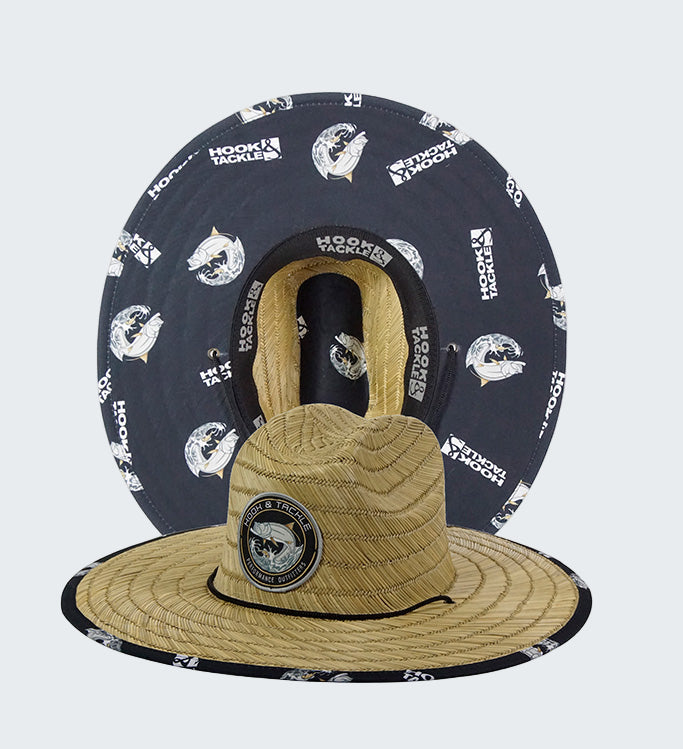 Two hats, one straw and one navy with white patterns, on a white background.
