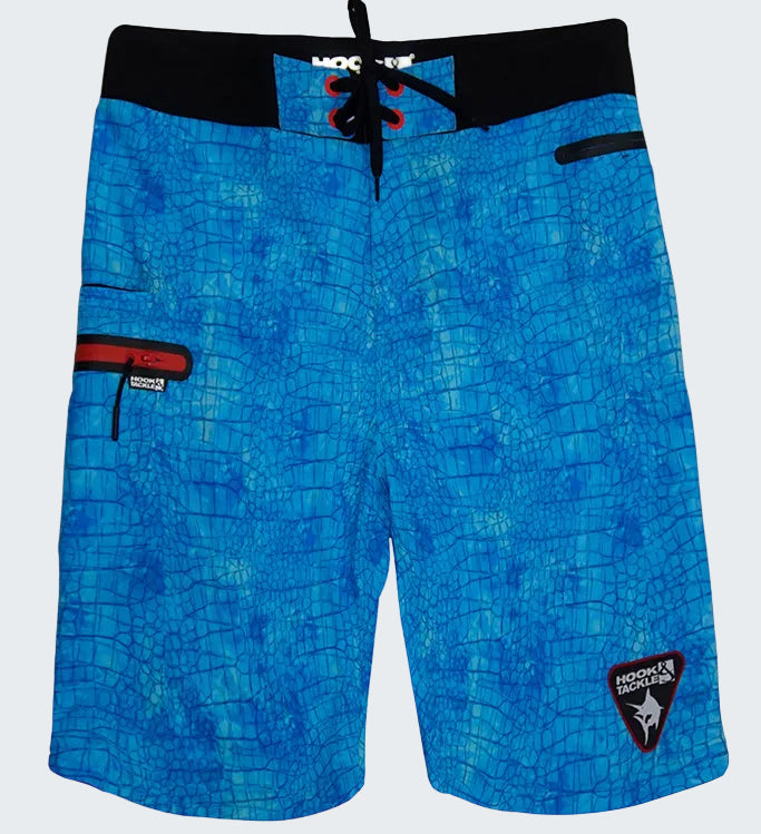 Blue patterned board shorts with a brand logo on a white background
