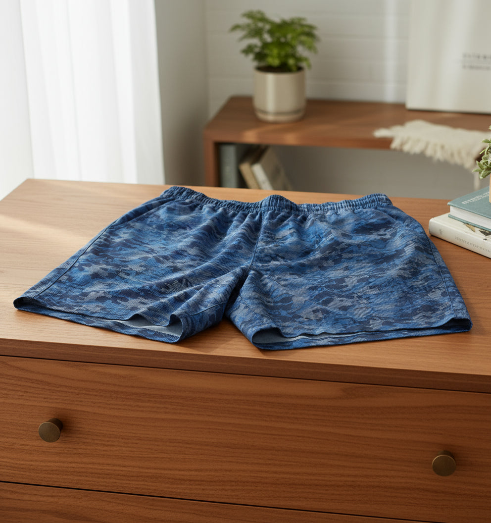 Blue camouflage shorts on a white background