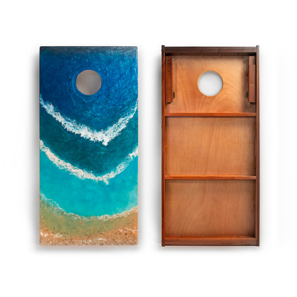 Two cornhole boards, one with a beach design and the other with a wooden texture.