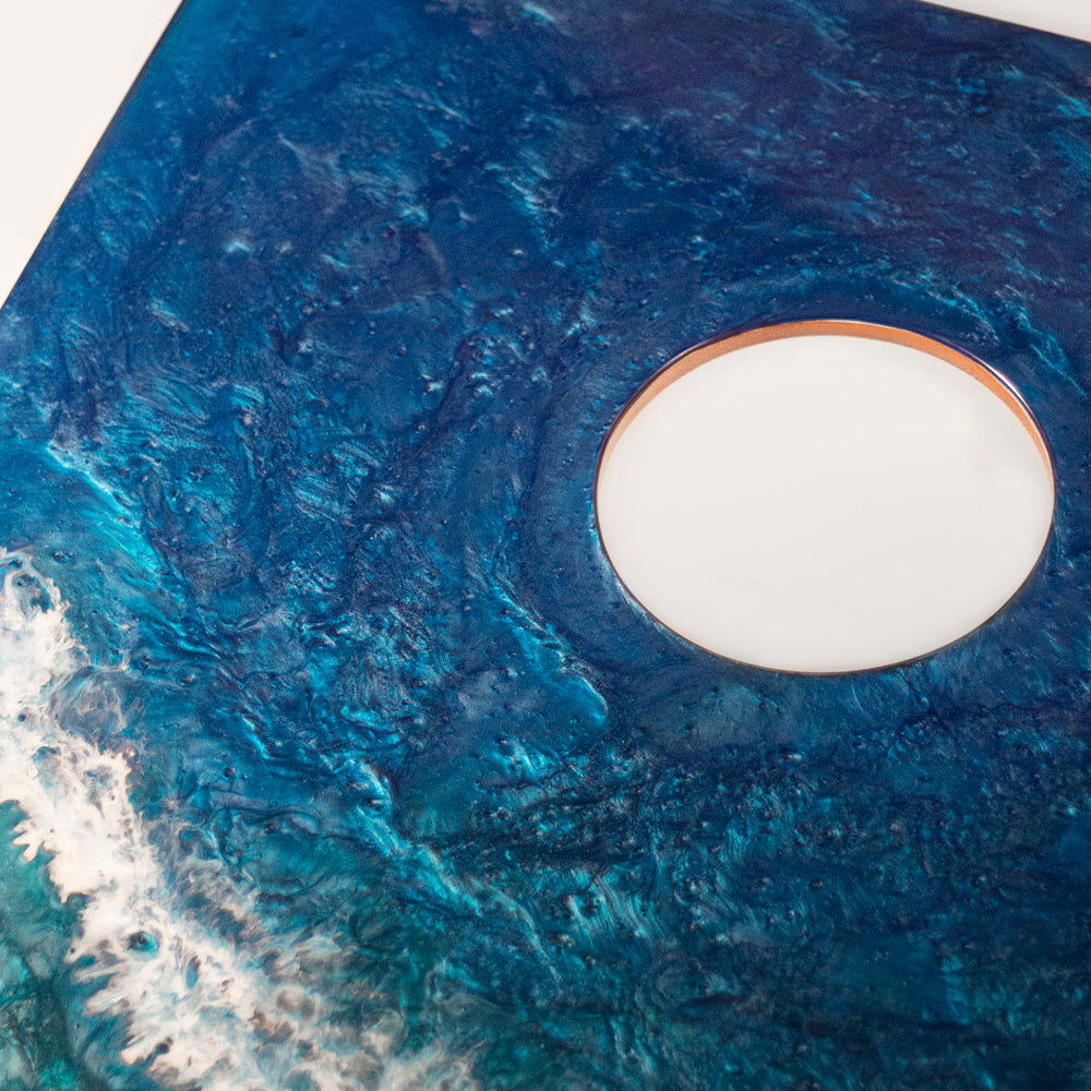 Close-up of a blue textured surface with a circular white object in the center.