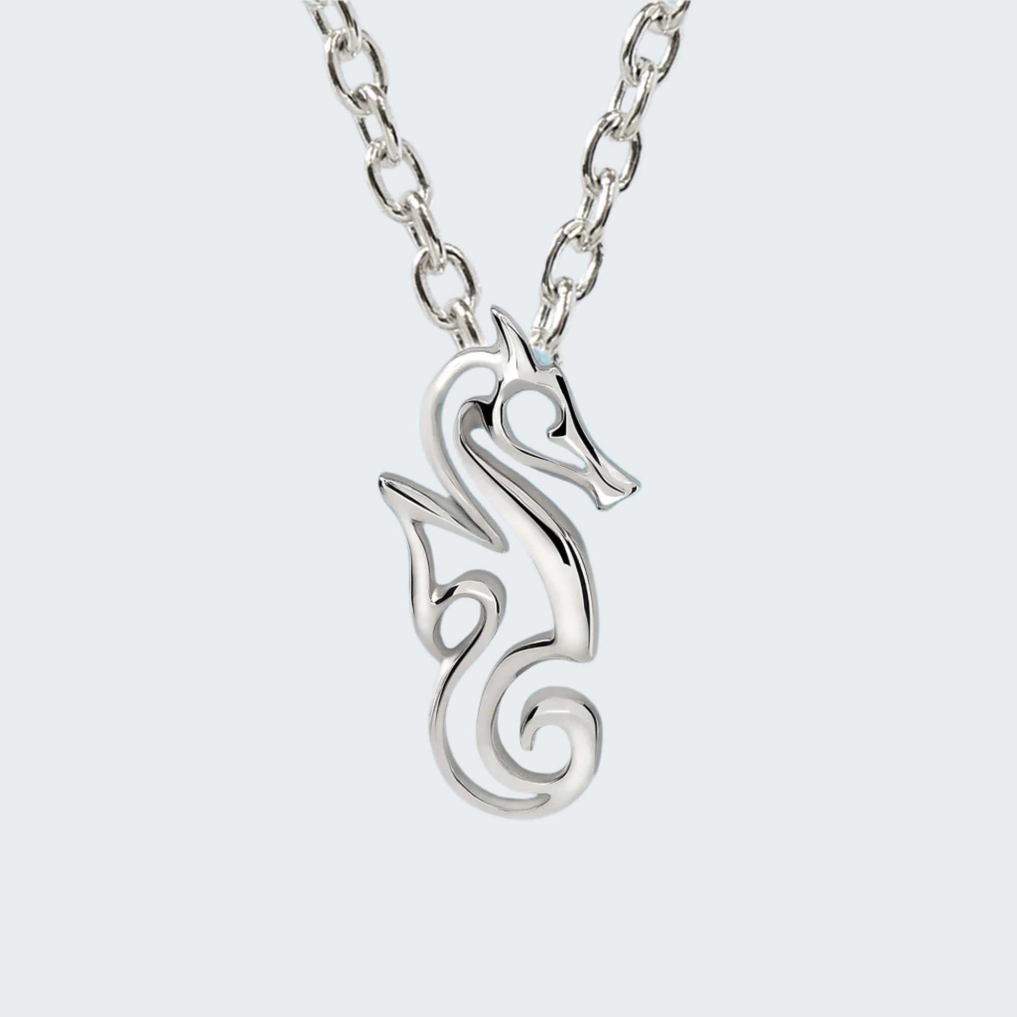Silver seahorse necklace with a blue ocean background