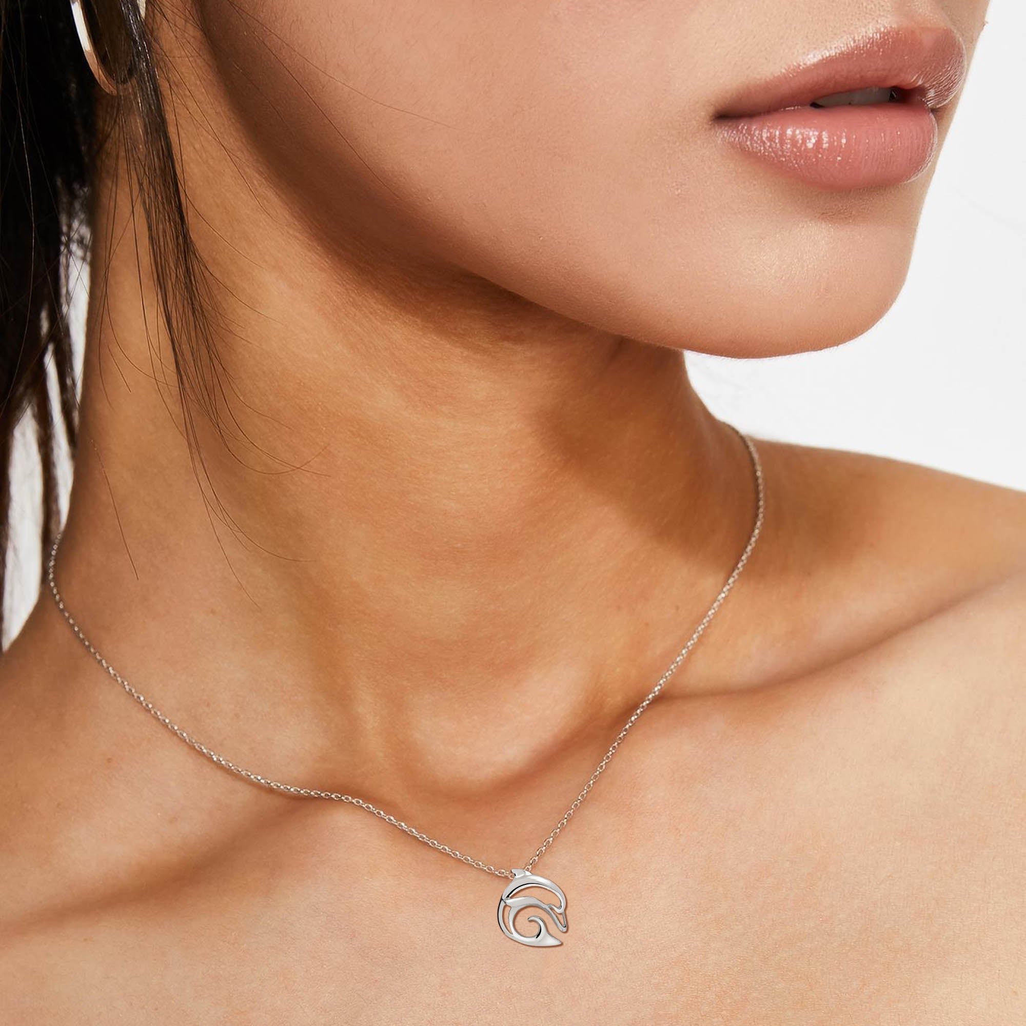 Silver necklace with a wave pendant worn by a model