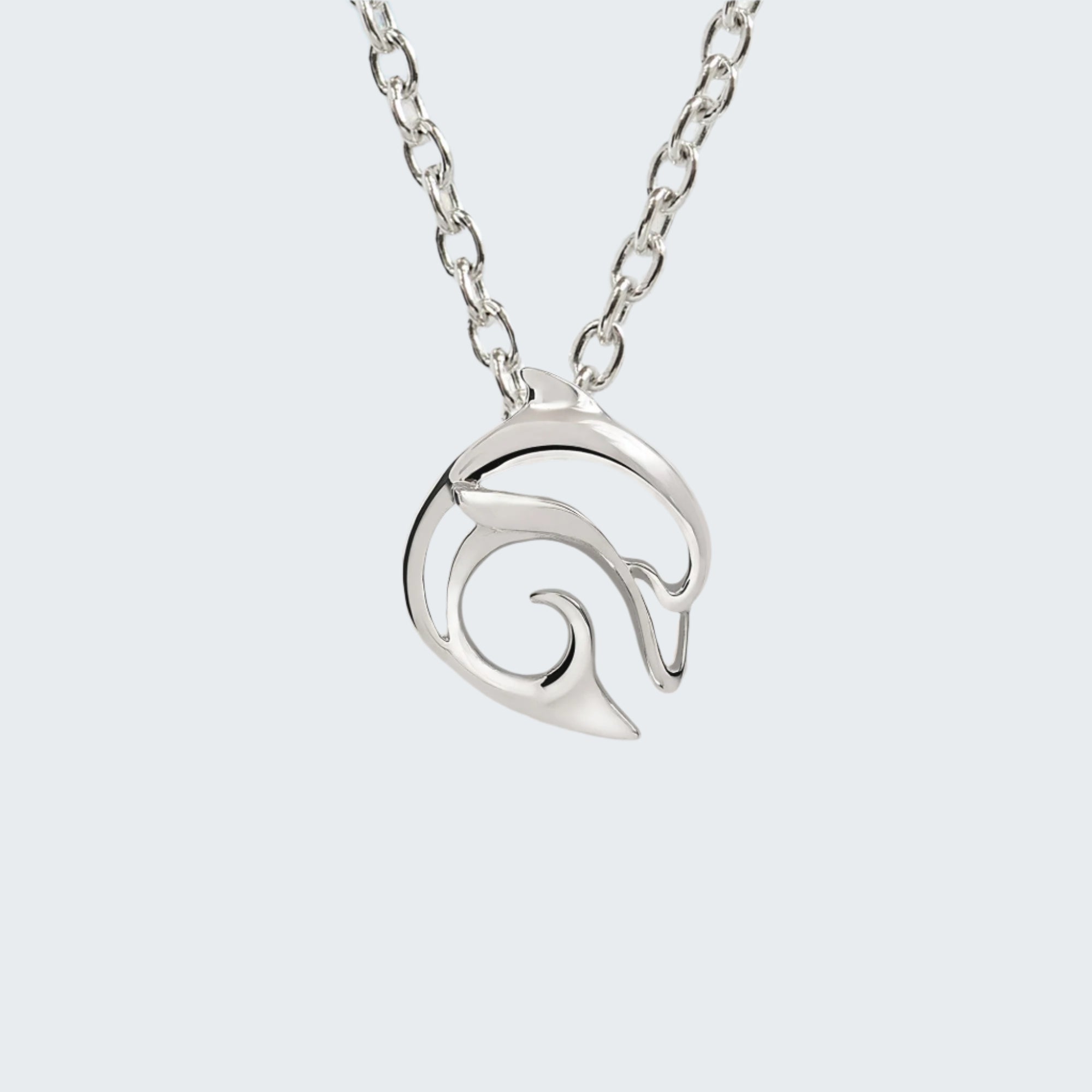 Silver wave pendant necklace on a chain with a beach background
