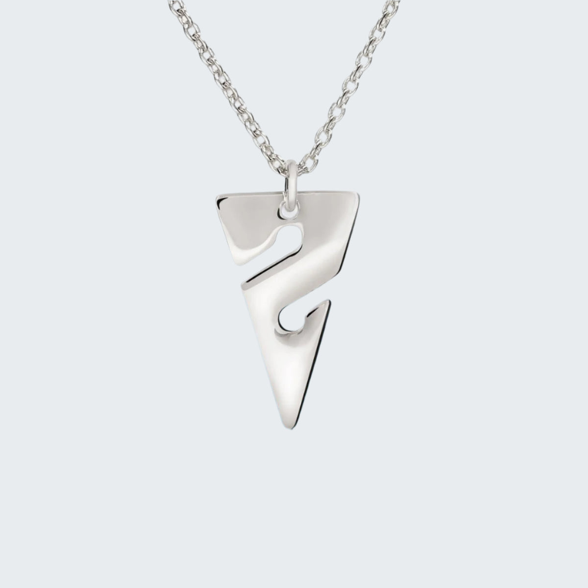 Silver necklace with a unique pendant on a light gray background