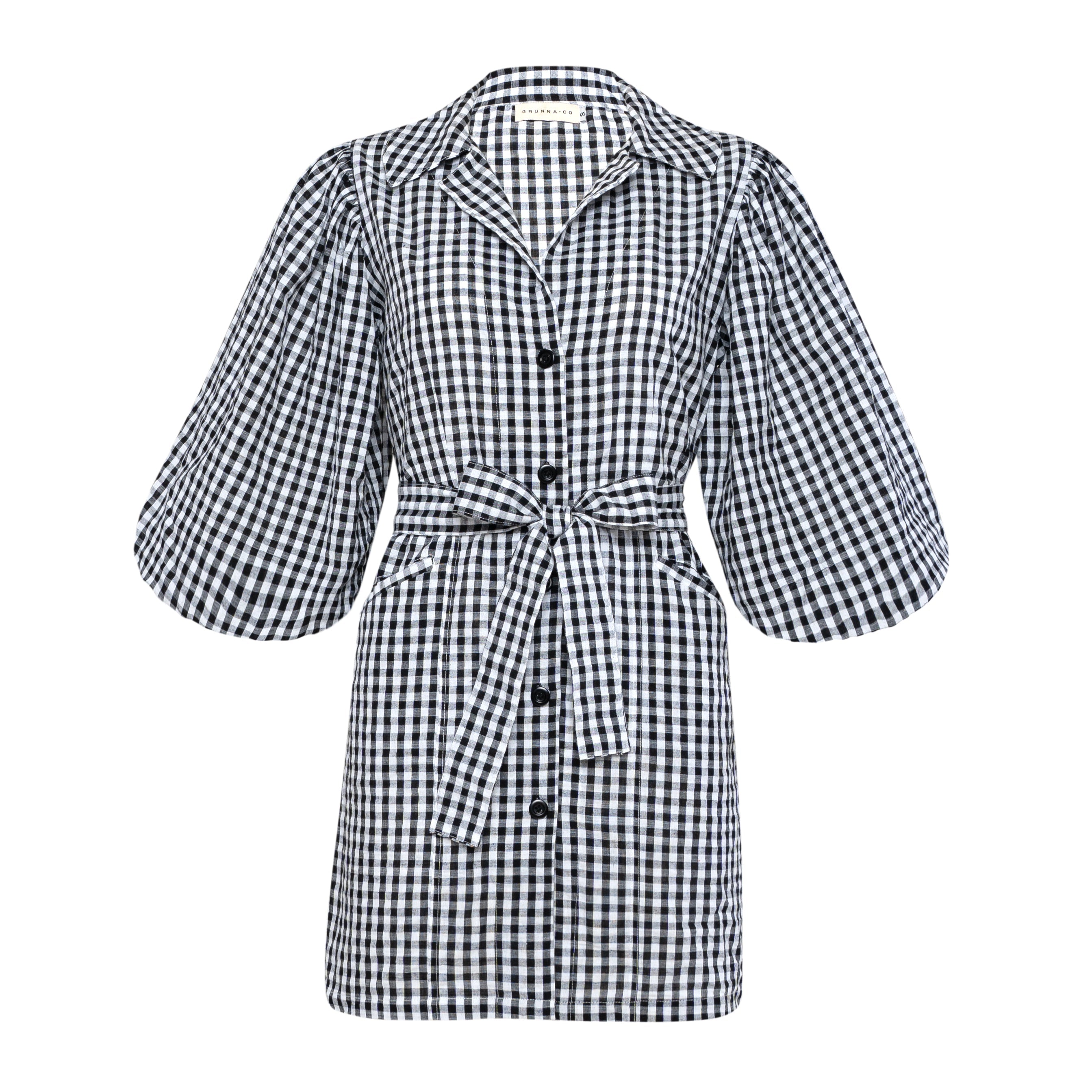 Black and white checkered dress with puff sleeves on a white background