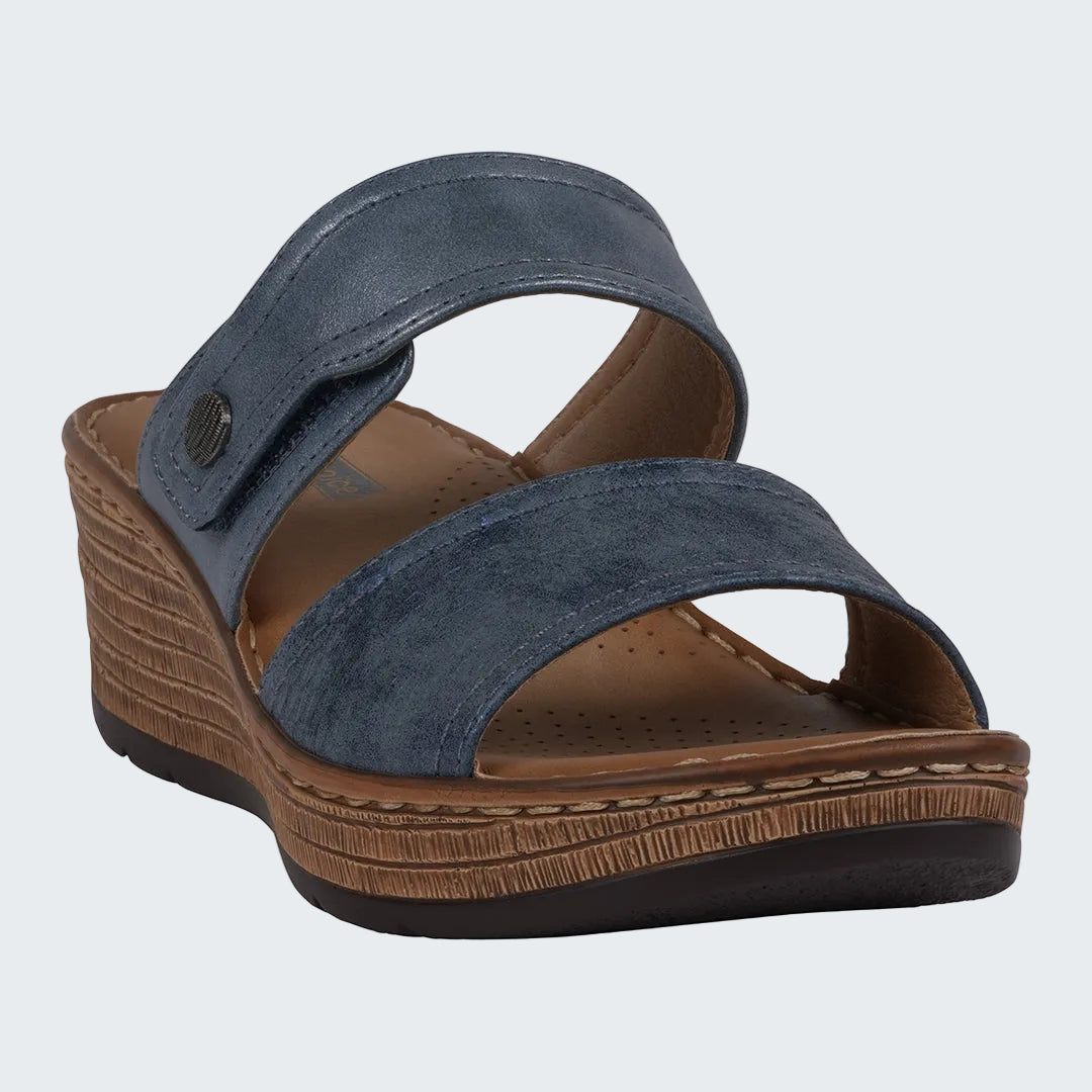 Blue wedge sandal with brown sole on a white background