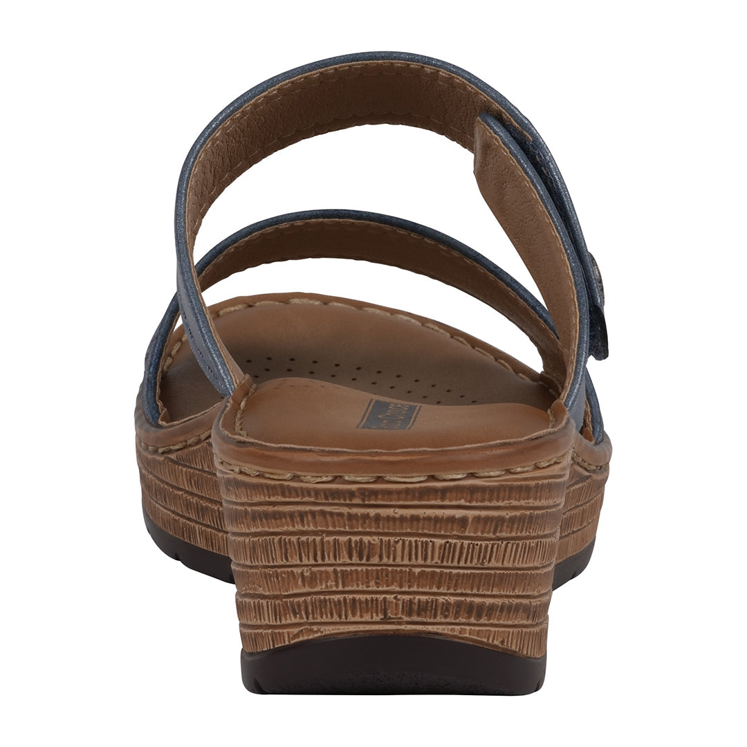 Brown sandal with a textured sole on a white background