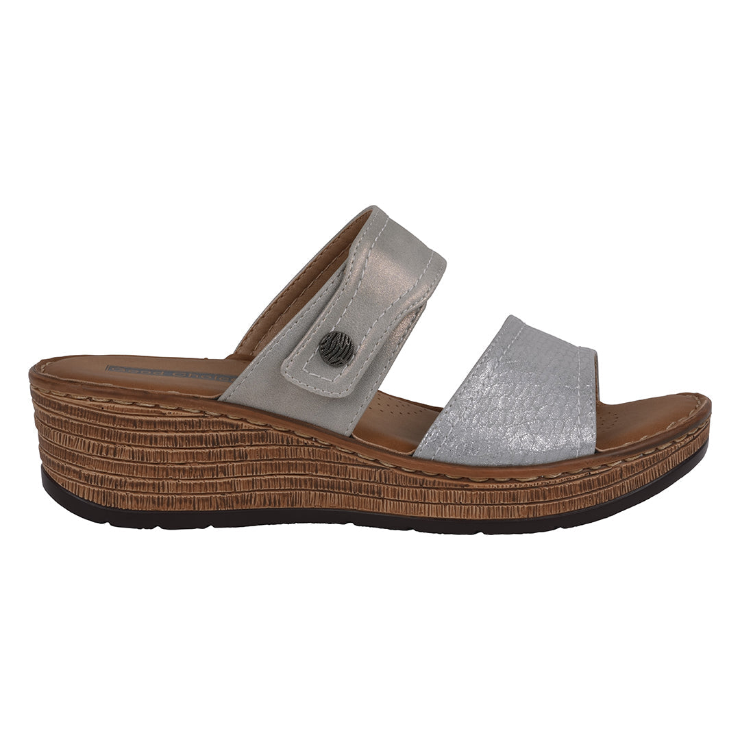 Silver sandal with a brown sole on a white background