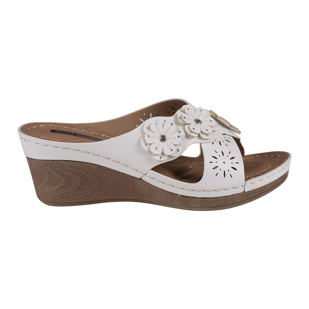 White wedge sandal with floral design on a white background