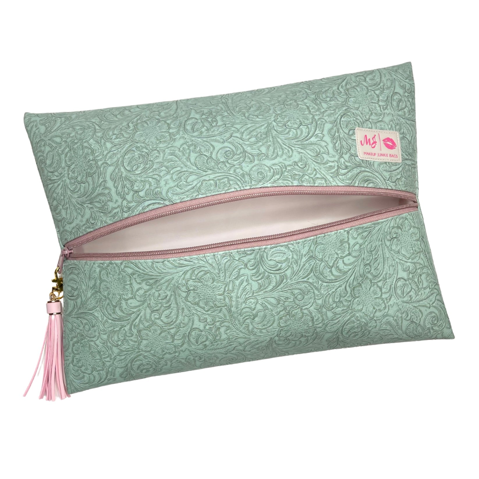 Green patterned pouch with pink zipper and tassel on a white background