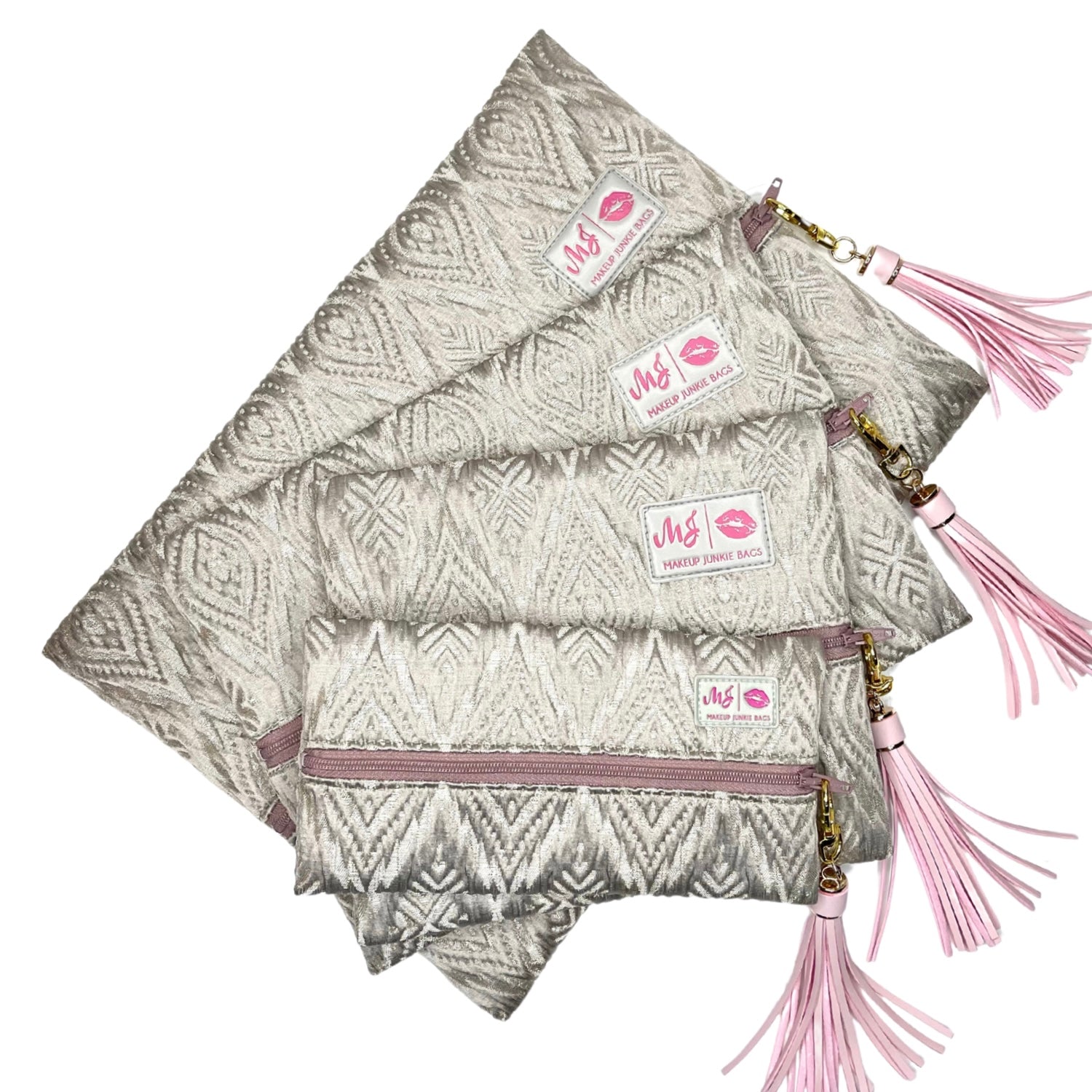 Set of three patterned bags with pink tassels and visible brand logo on a white background