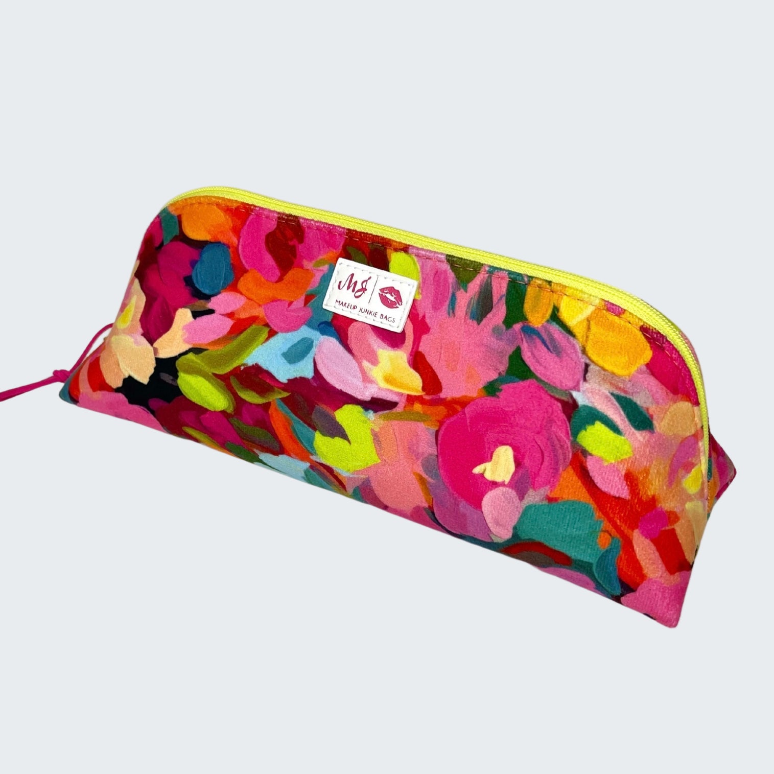 Colorful floral-patterned pouch with a visible brand label on a white background