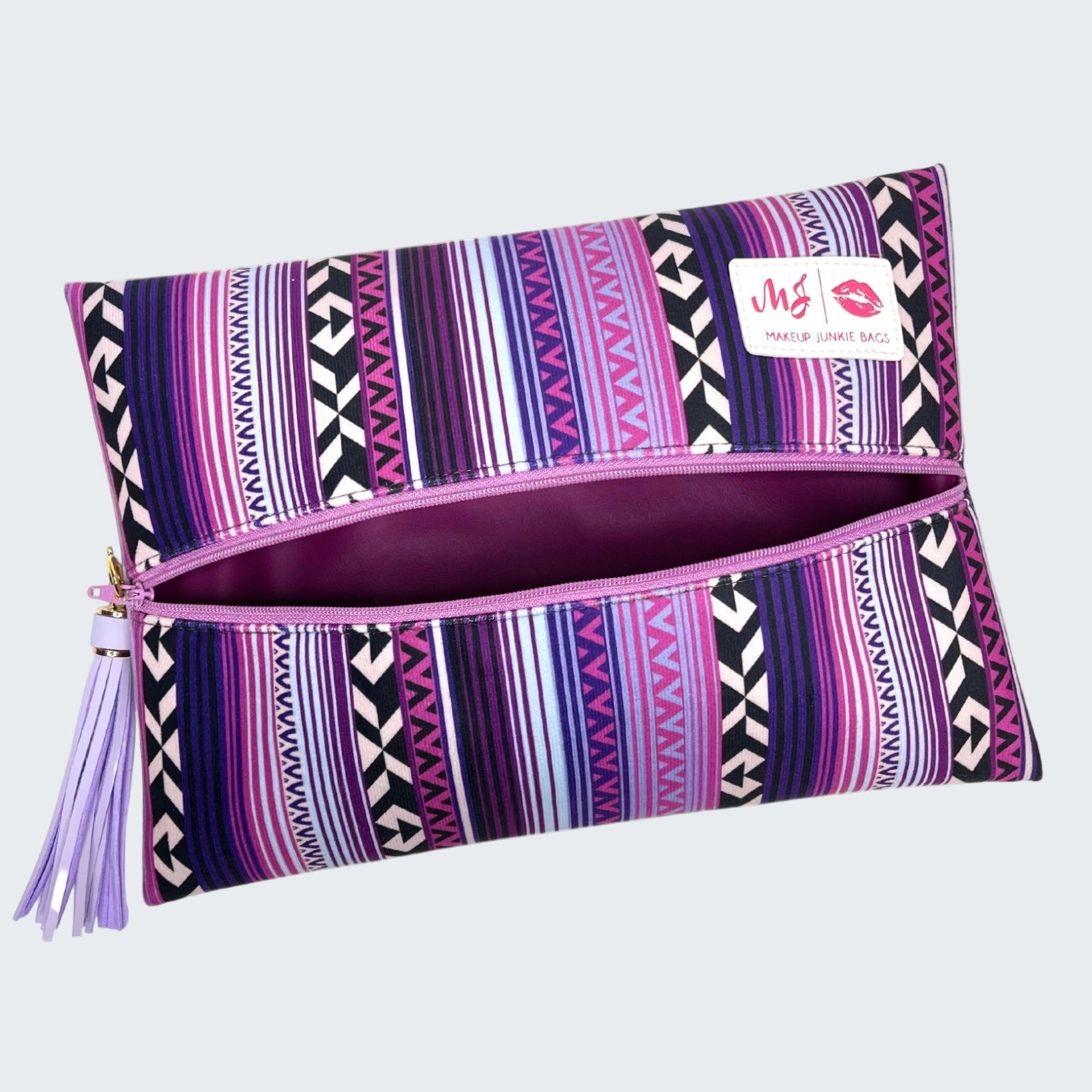 Purple patterned pouch with a visible brand label on a white background