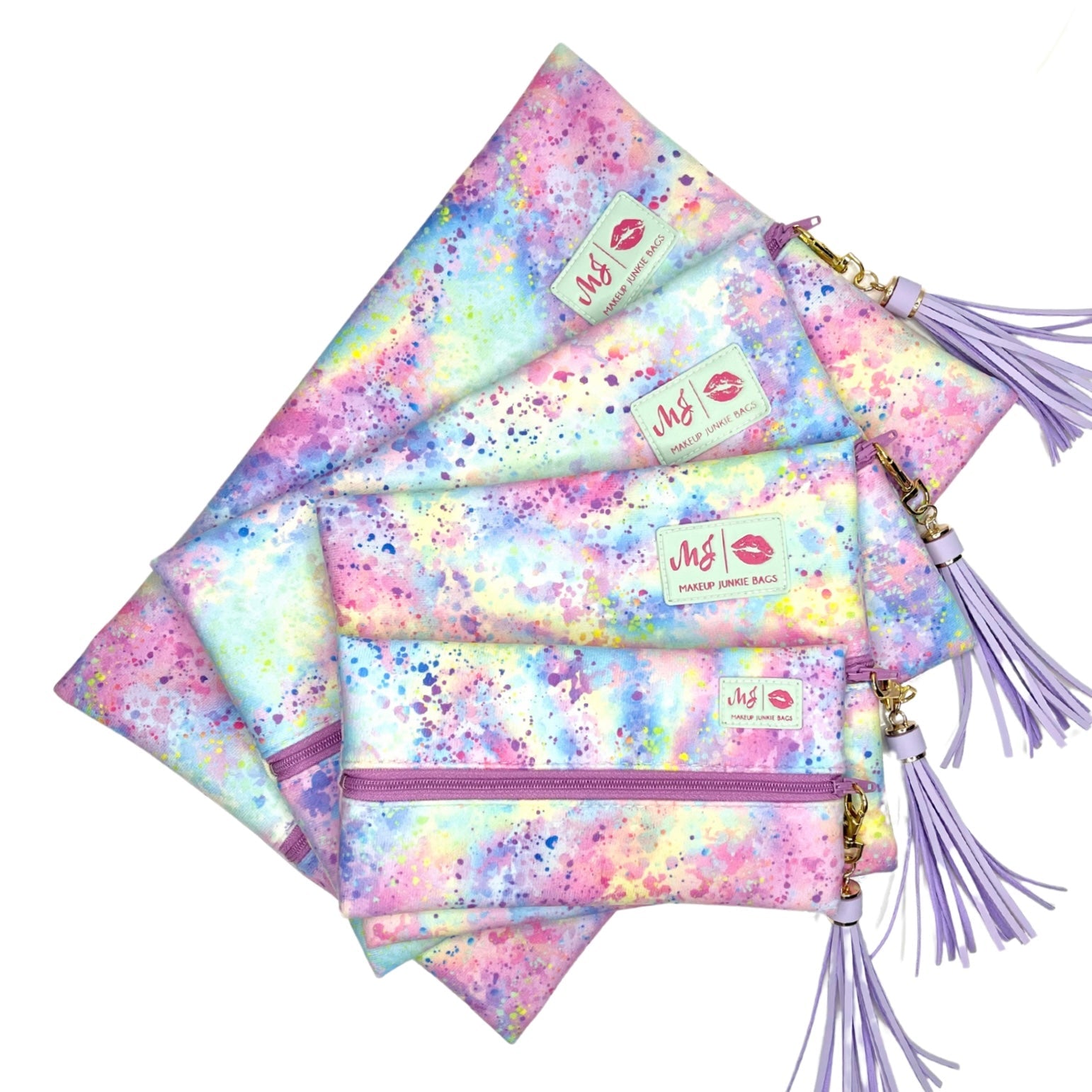 Set of colorful makeup bags with tassels on a white background