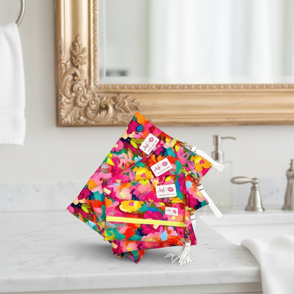 Colorful floral-patterned pouches with visible brand labels on a white background