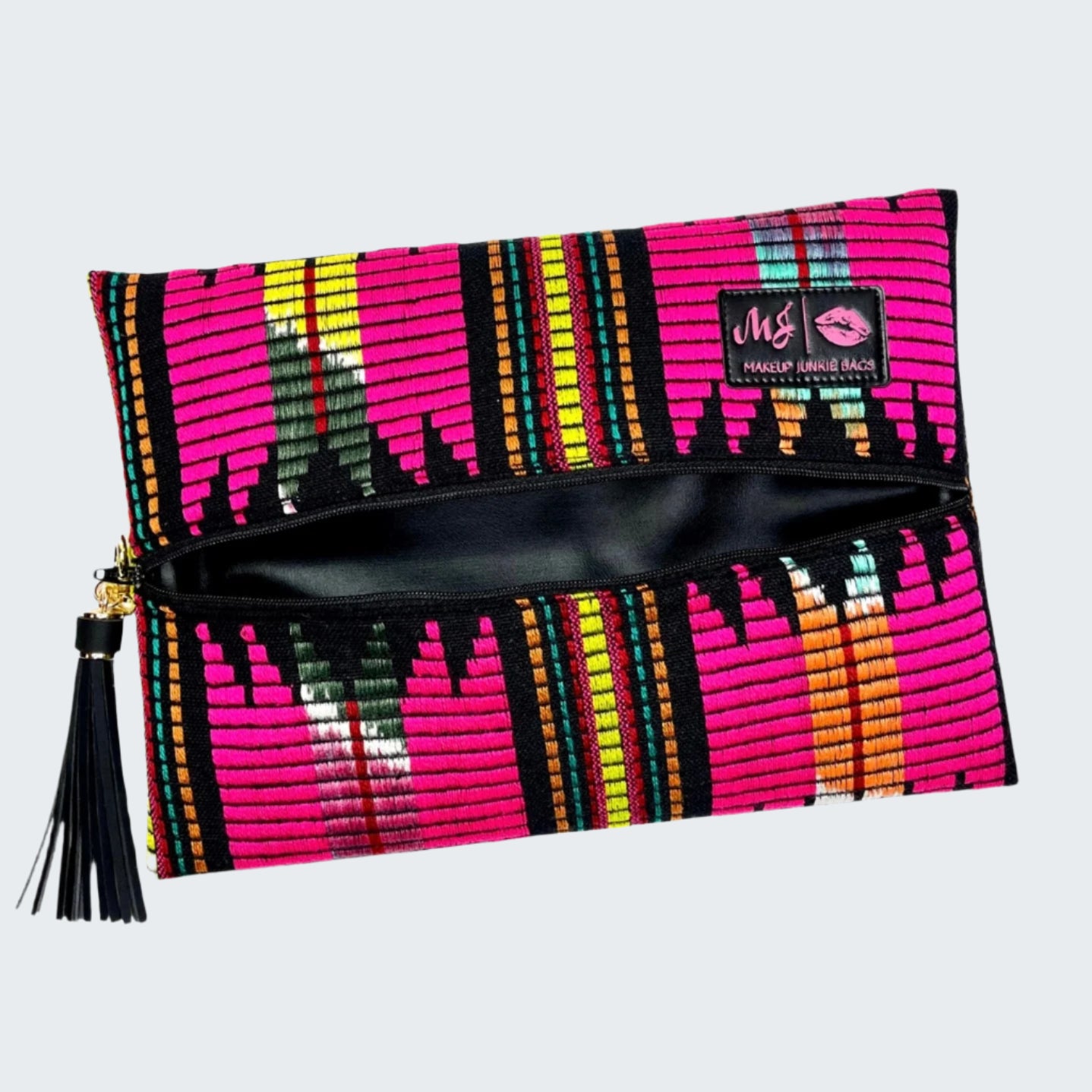 Colorful patterned clutch bag with a tassel on a white background