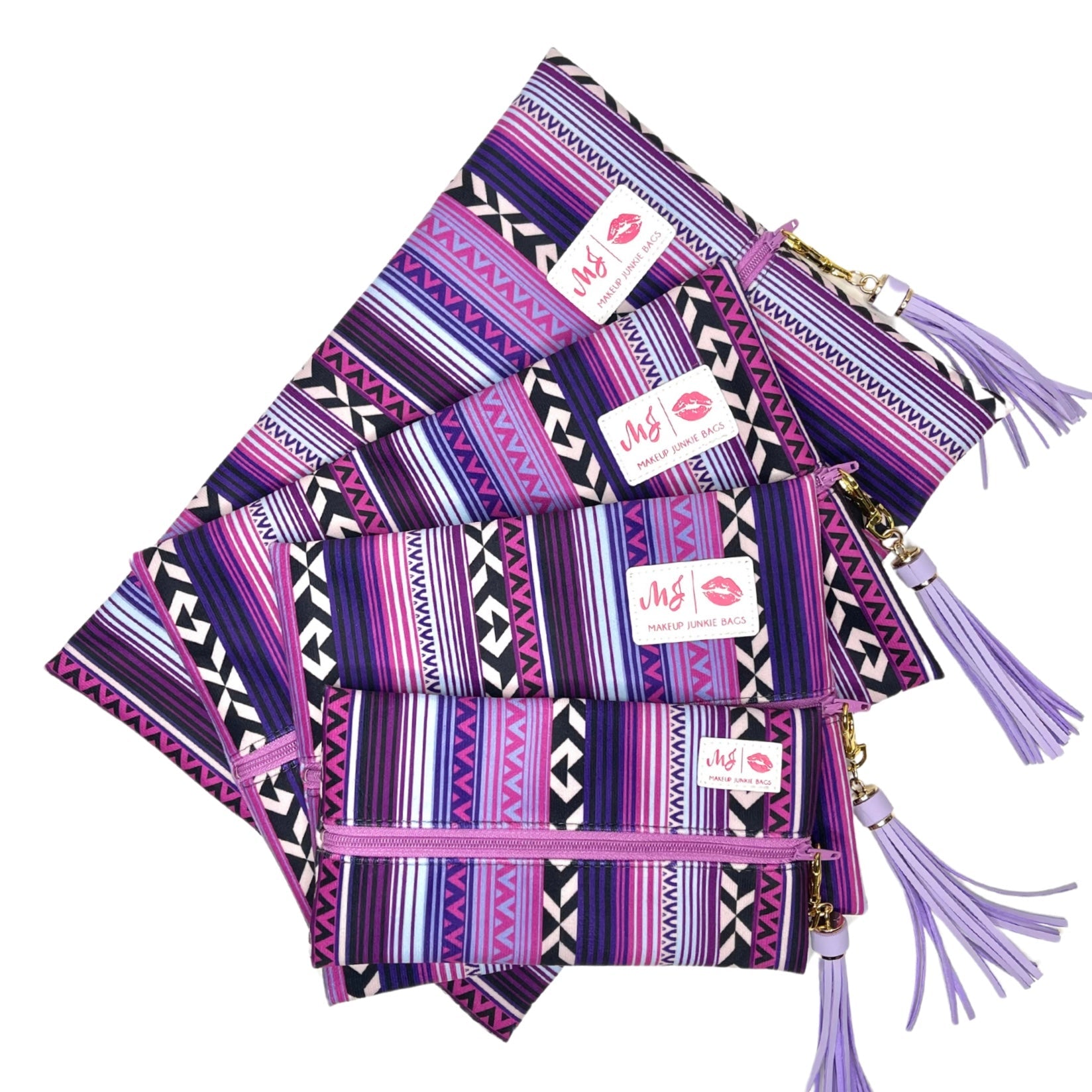 Set of purple patterned pouches with tassels on a white background