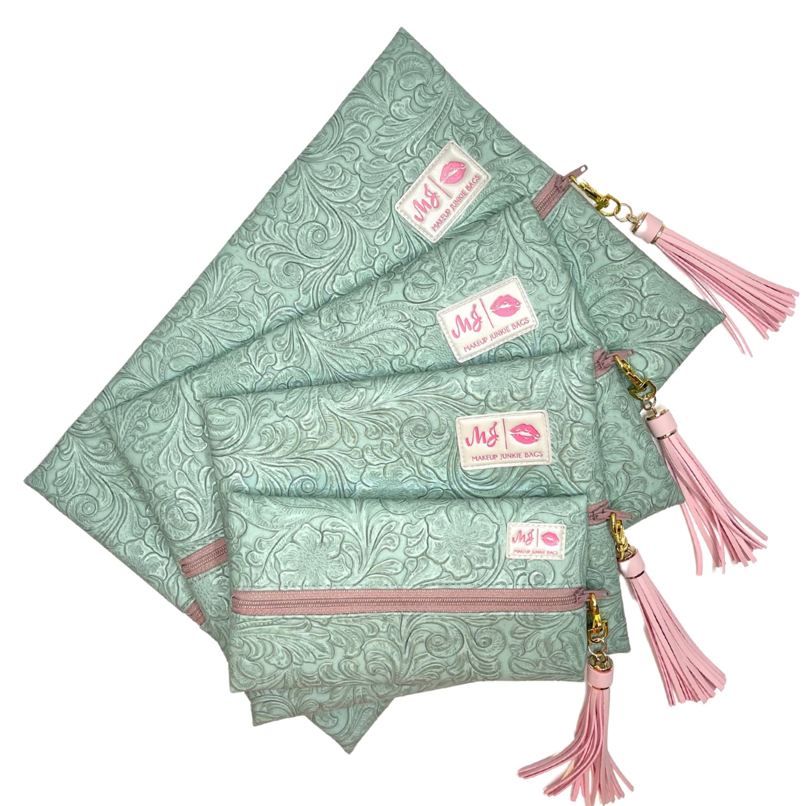 Set of green patterned pouches with pink accents and tassels on a white background