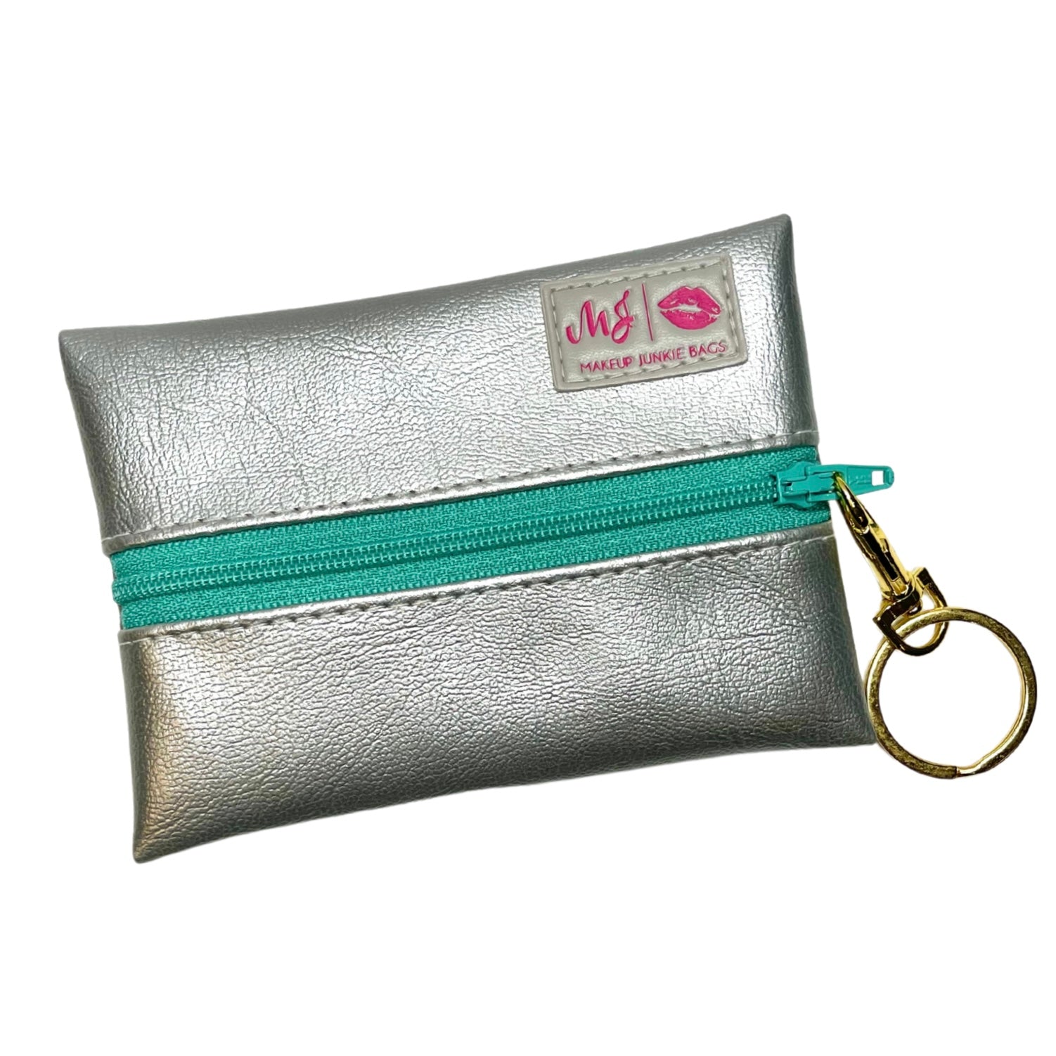 Silver makeup junkie bag with a turquoise zipper and gold keychain on a white background