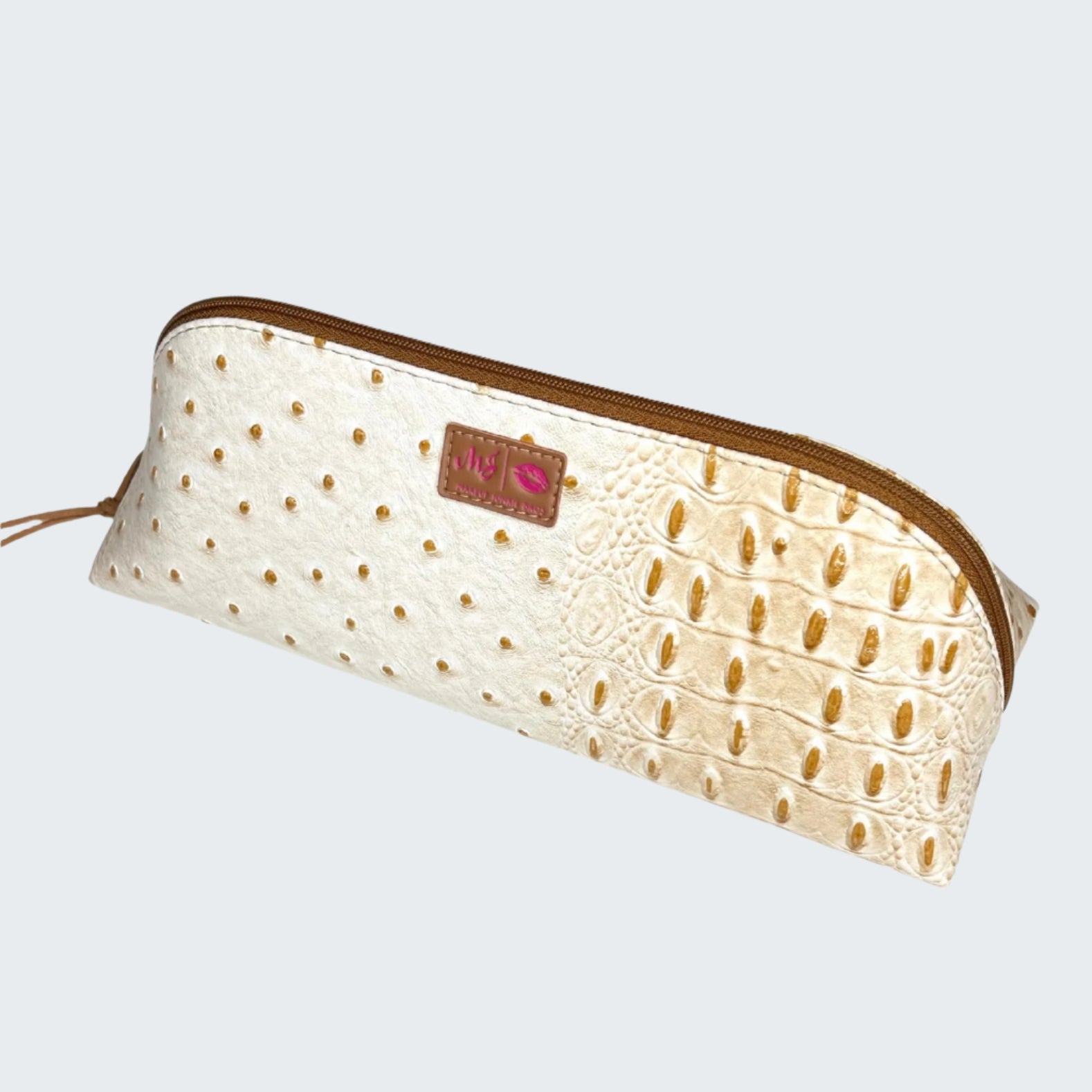 White pouch with gold crocodile pattern and brown zipper on a white background