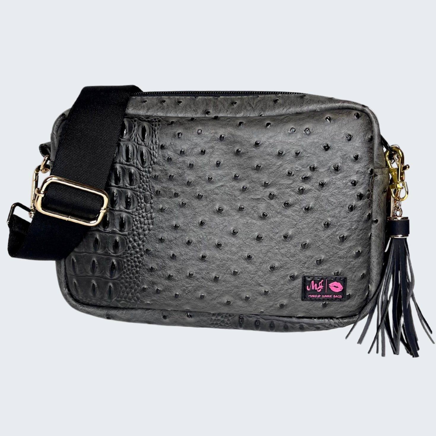 Black textured handbag with a tassel on a white background