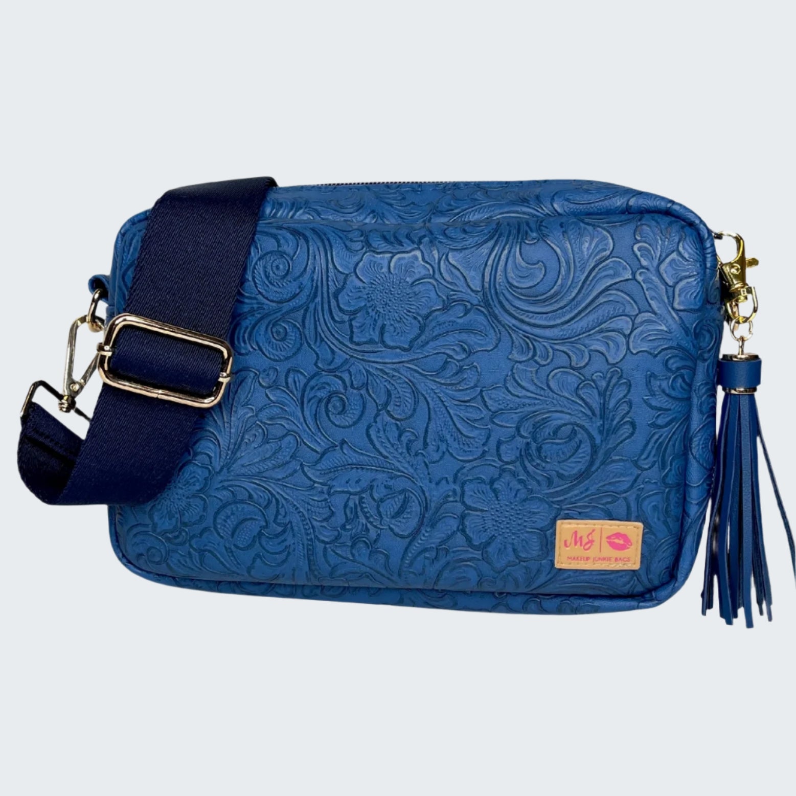 Blue floral-patterned handbag with a strap and tassel on a white background