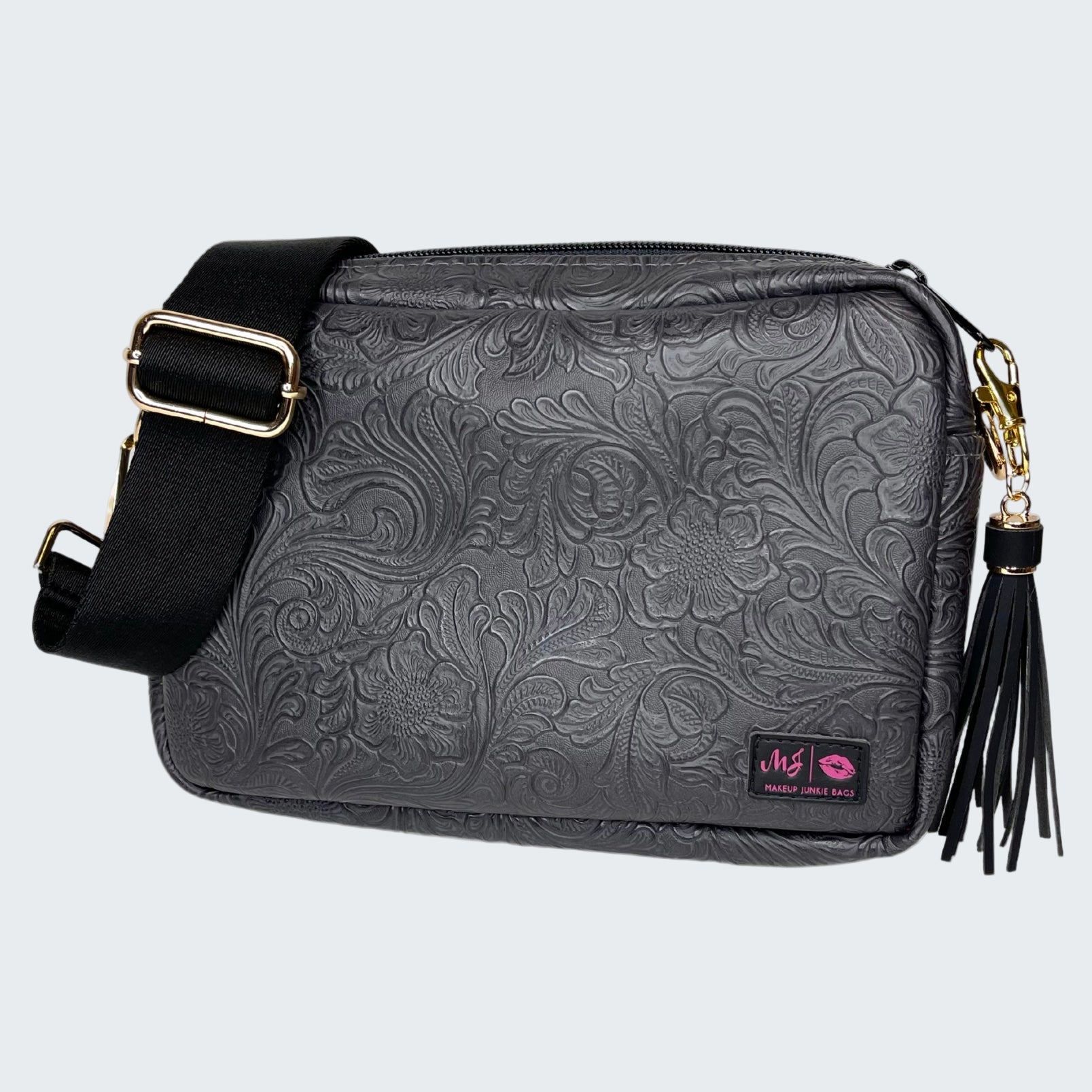 Black floral embossed handbag with a tassel on a white background