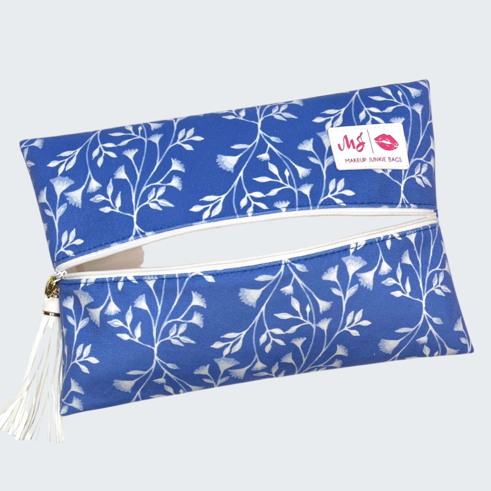 Blue floral makeup bag with a visible brand logo on a white background