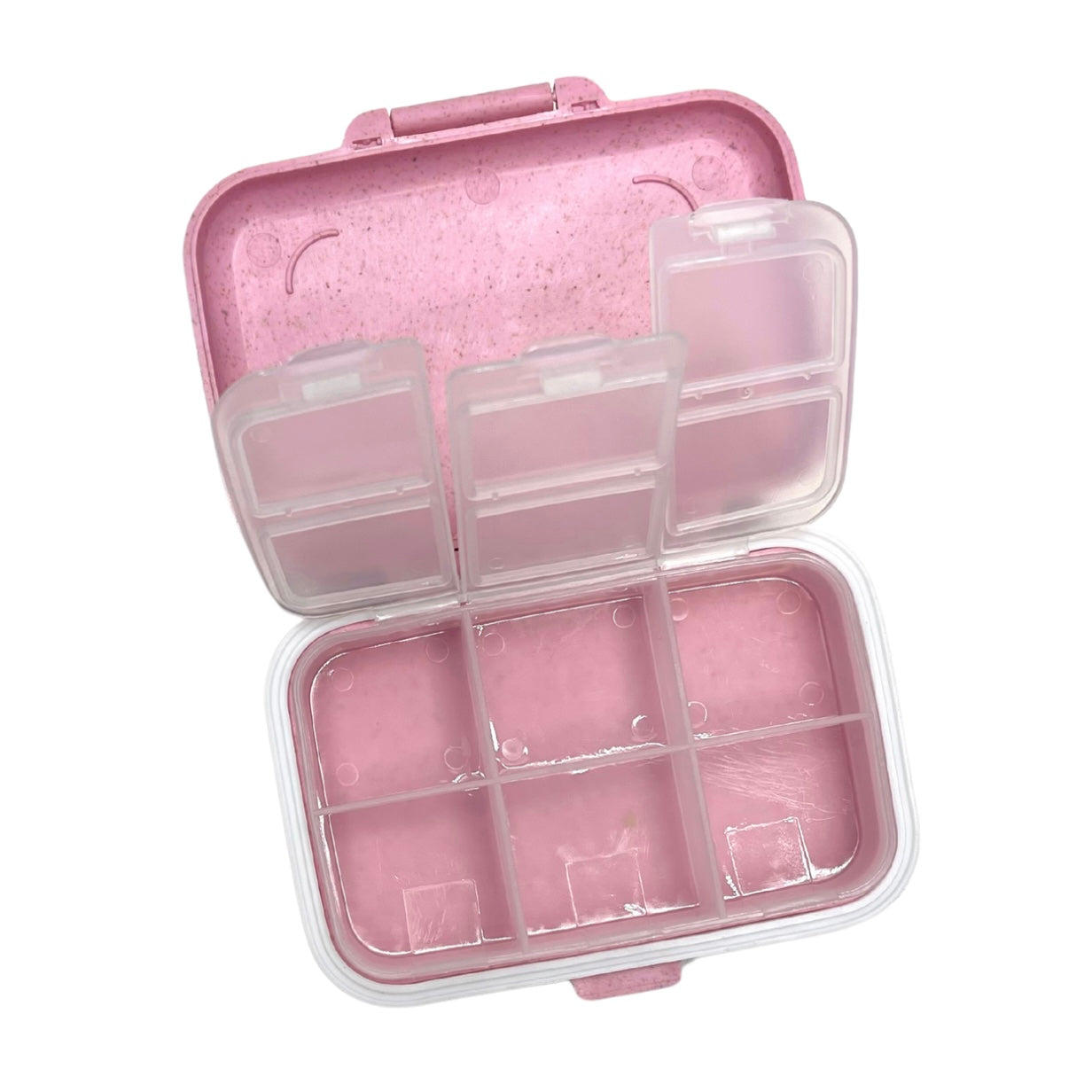 Pink compartmentalized container with a clear lid on a white background